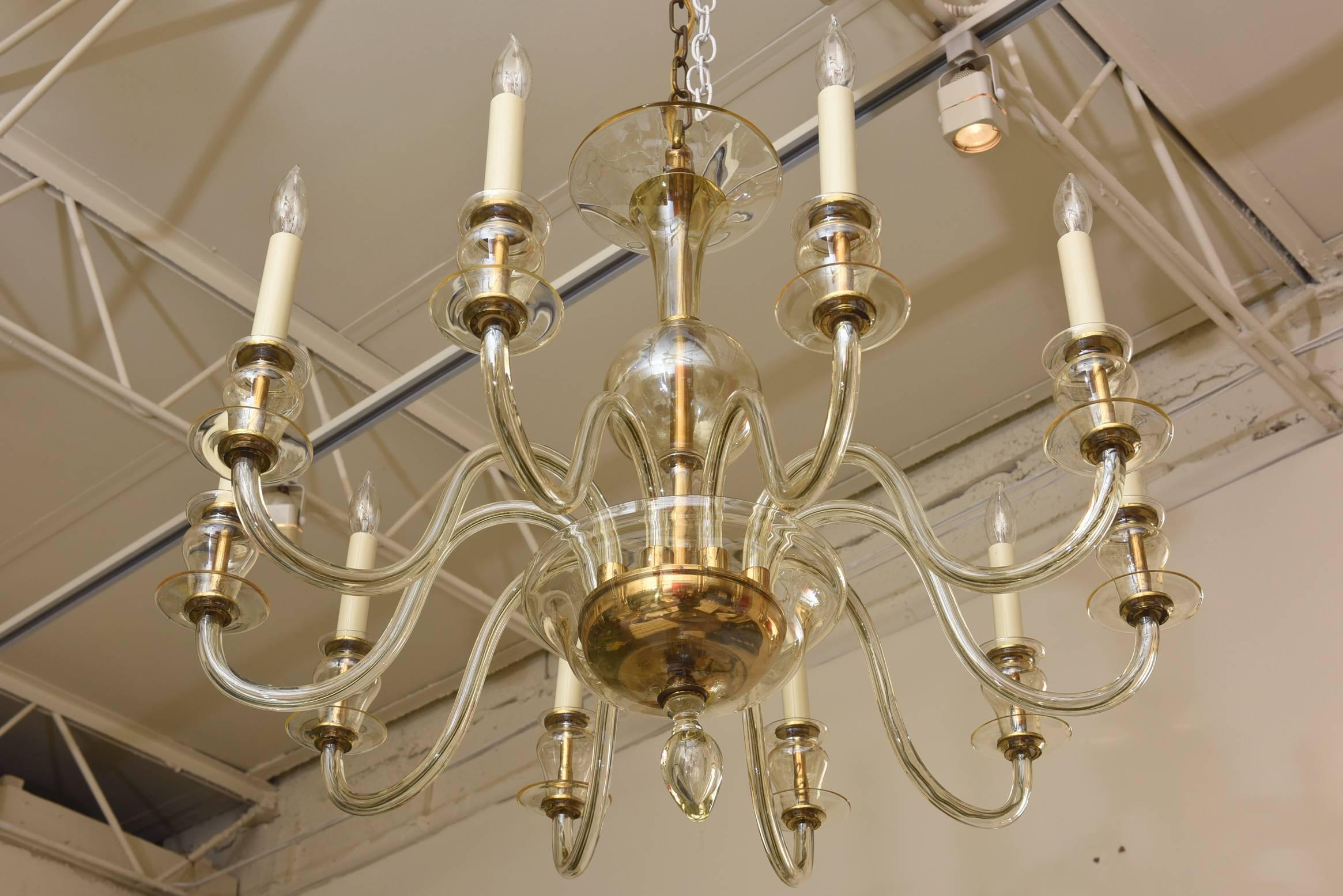 This elegant and classic Italian Murano chandelier bridges traditional with modern. It is clear glass with lots of gold aventurine.
Ten arms with candelabra bulbs and sleeves. The photos do not do justice to the beauty of this chandelier.

NOTE: