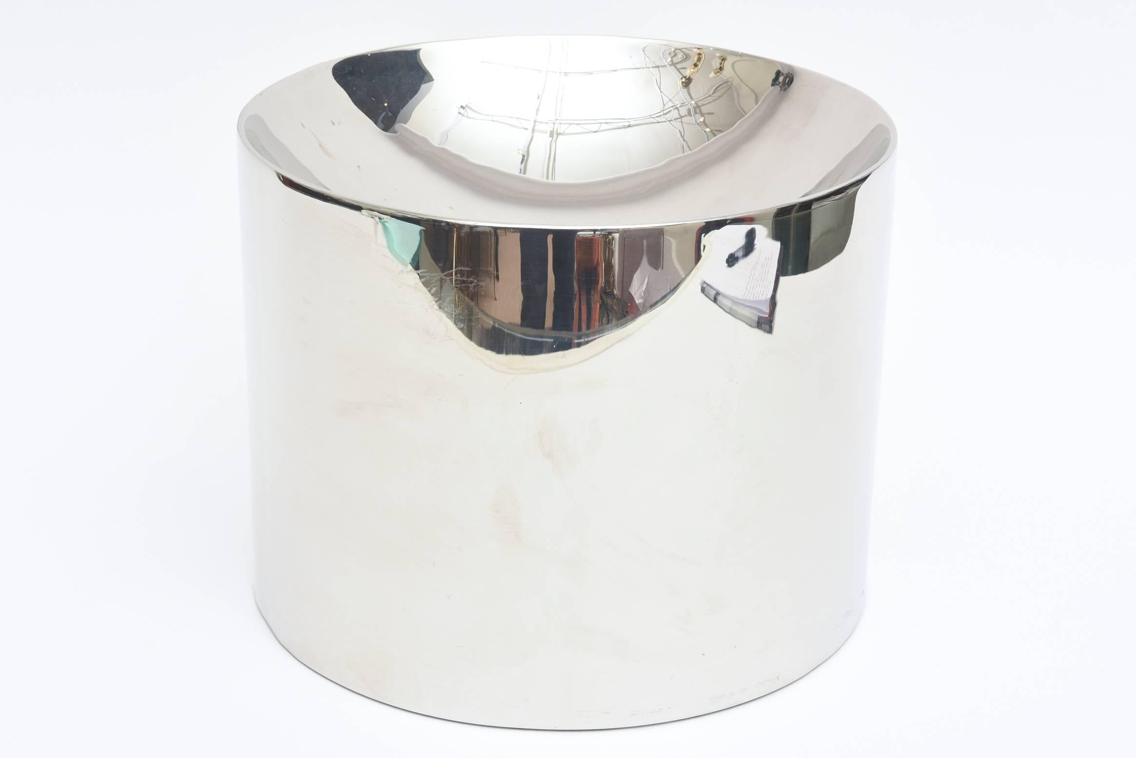This heavy and solid polished Italian stainless steel sculptural bowl or vessel is monumental. 
It would be a great receptacle for mail on a console or for serving.
It is dramatic and even has the look of an Anish Kapoor sculpture. One that you can