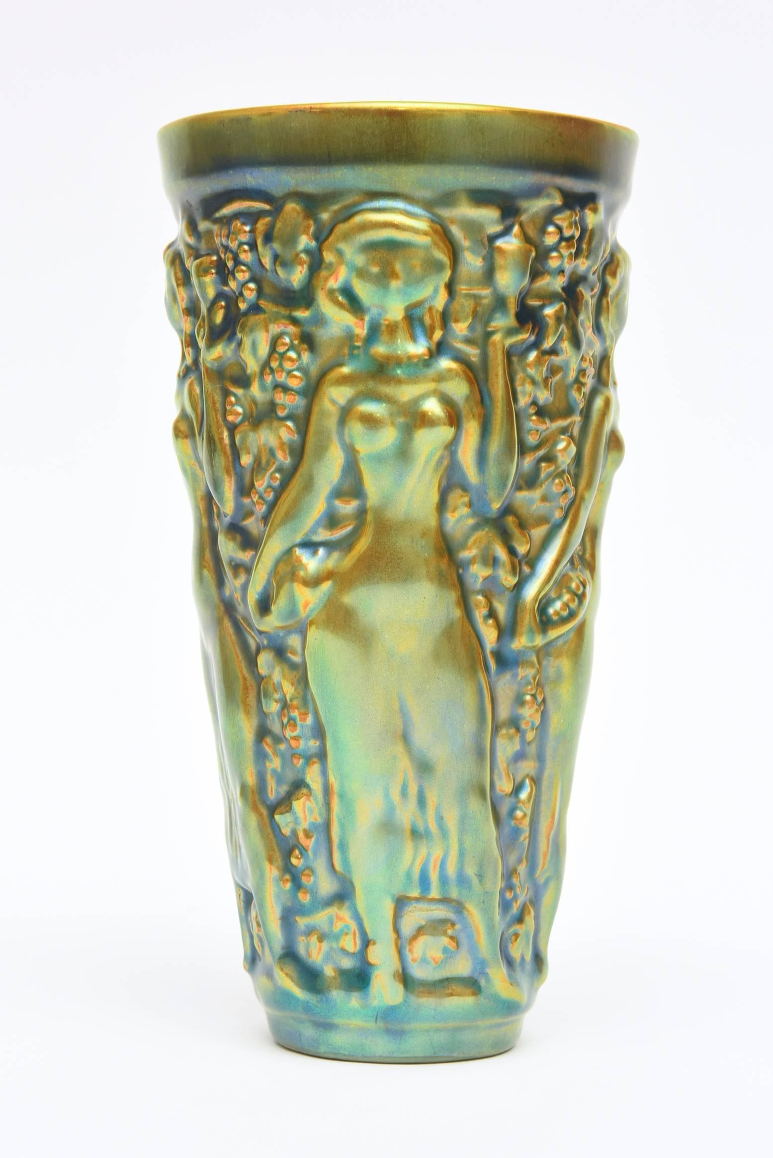 This very vintage textural and raised forms of this glazed ceramic vase is by the Hungarian artist named Zsolnay. It is a glorious combination of color of elegant sensual nude reliefs in this small vase vessel and decorative ceramic luster glazed