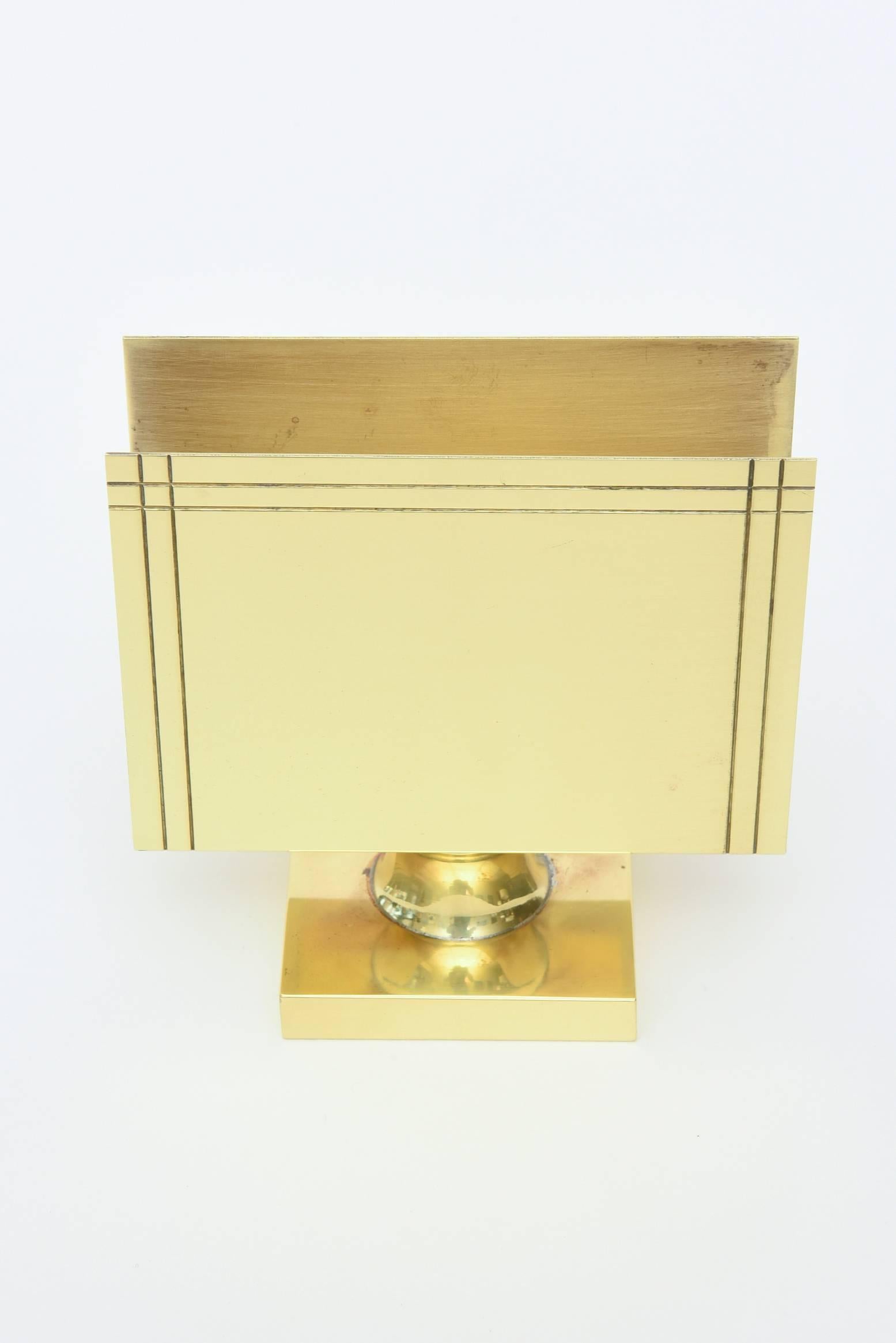 This classic and timeless solid polished brass holder is stamped on the bottom Made by Dorlyn-Silversmiths; that is who executed Tommi par zinger designs in metal.
At one time, this also may have been used for large matchbooks.
What a great desk
