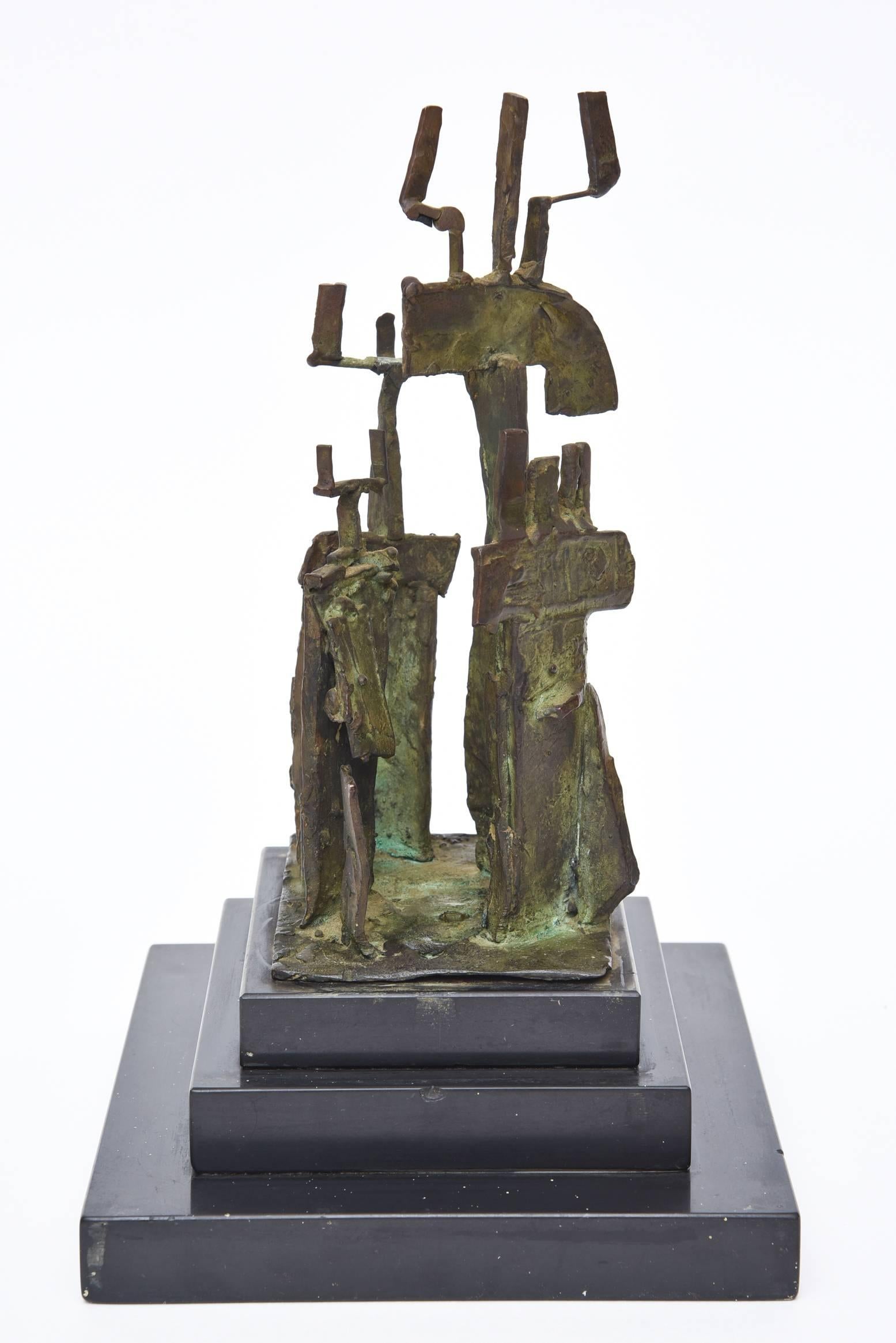The three-step black marble base is home to the bronze Mid-Century Modern sculpture by Irma Stoloff, a NY artist. It is titled 