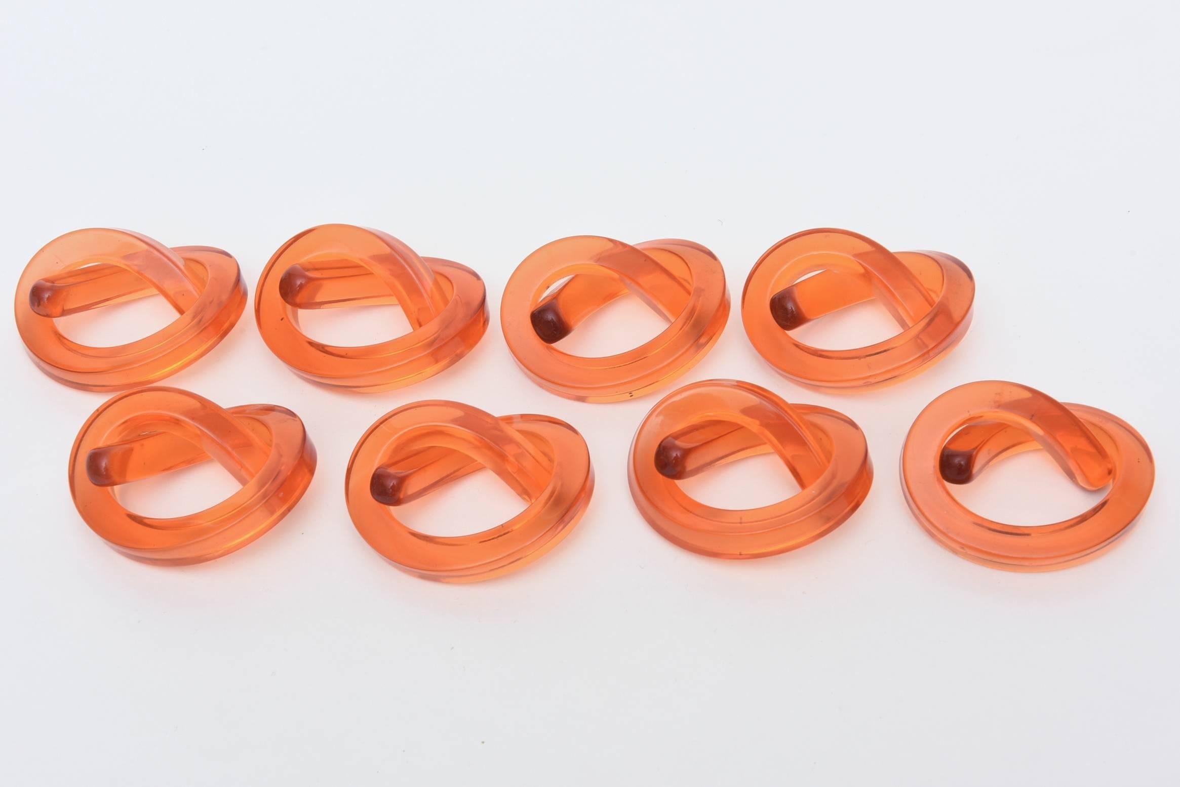 What a great table setting these make with their twisted pretzel shape forms for
napkin rings.
The color is more of a melon orange with some translucency.
These Dorothy Thorpe napkin rings are sculptural Lucite.

NOTE: THESE WILL BE ON THE