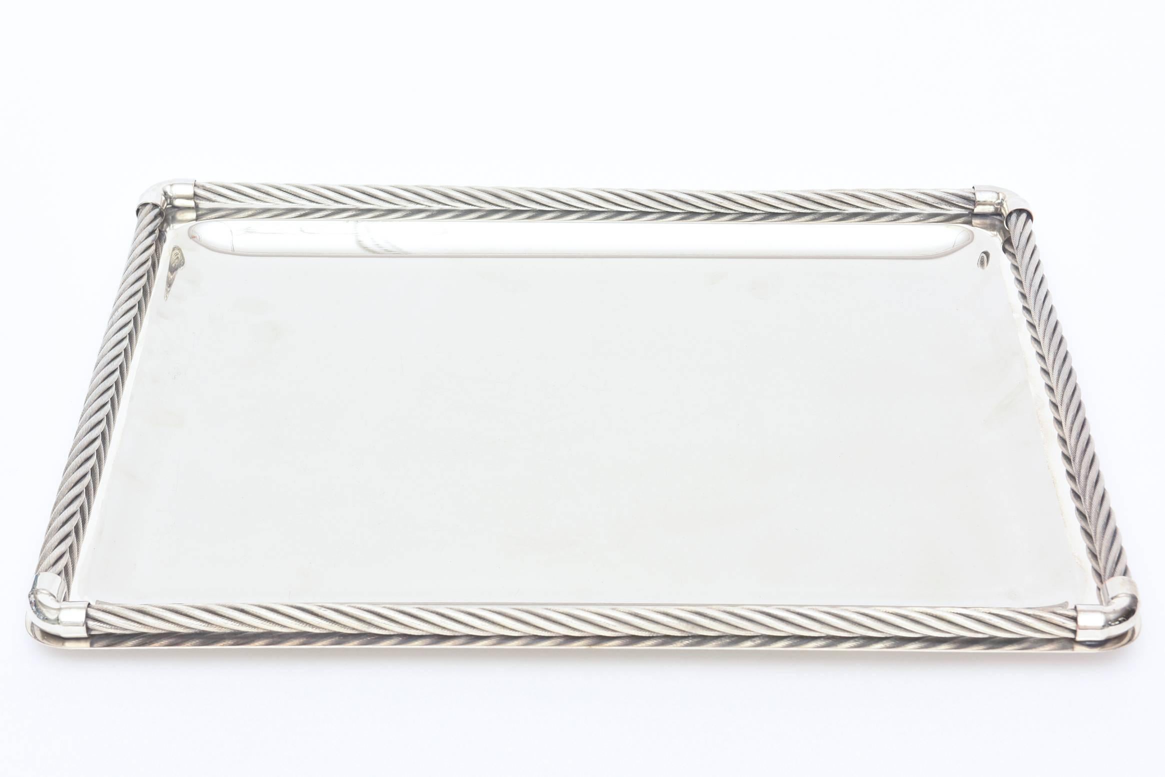 This wonderful and versatile  Italian Gucci silver plate tray has both modern and traditional elements to it. The braided /rope borders done in silver-plate add dimension. The  interior center is silver-plate also.
It is signed Co 10 Gucci made in