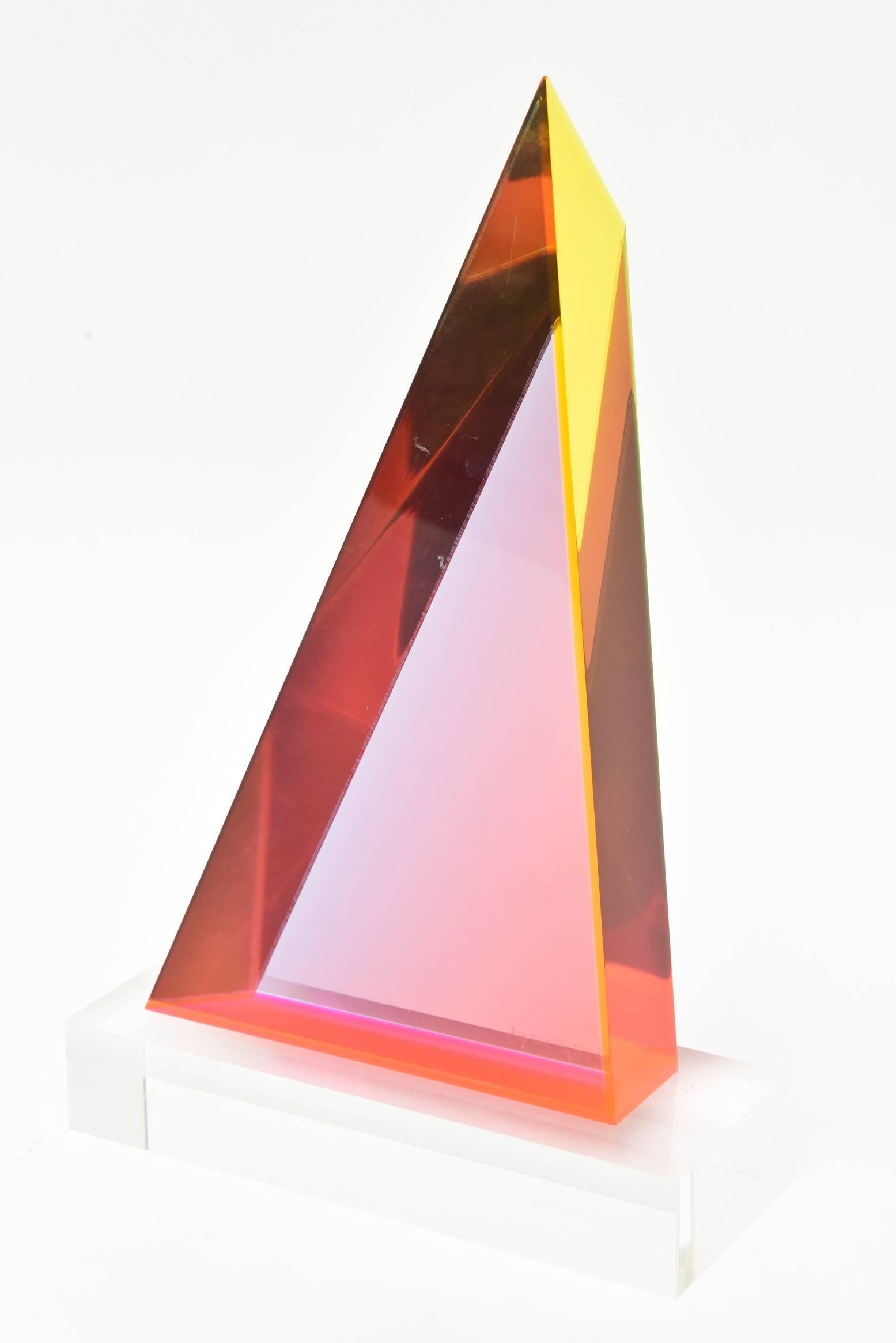 This fantastic, spectacular original and one of a kind Vasa Melich triangular geometric laminated Lucite sculpture varies from angle to angle and light to light. It is signed and dated 2005. The Lucite sculpture without the base is 12