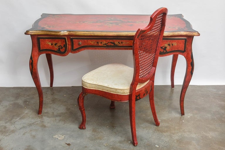 Very decorative hand painted and lacquered desk. With matching cane backed chair.