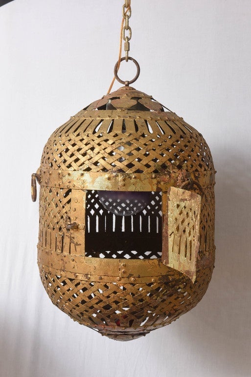 Pair of large, decorative hanging and lighted iron lanterns with basket weave pattern and gilt finish.