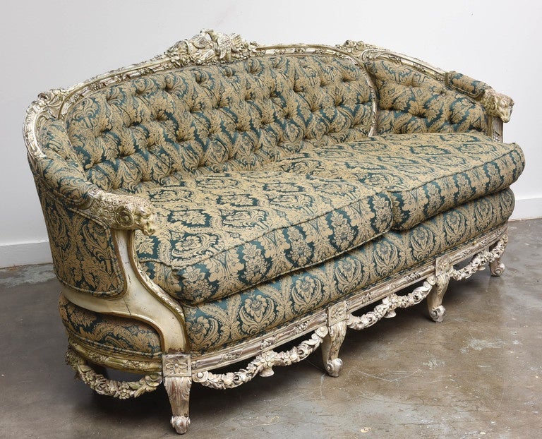 Beautifully detailed, carved sofa/chair with rams heads arms, love birds kissing on top of each piece, along with intricately carved floral swags on the bottom of both pieces.