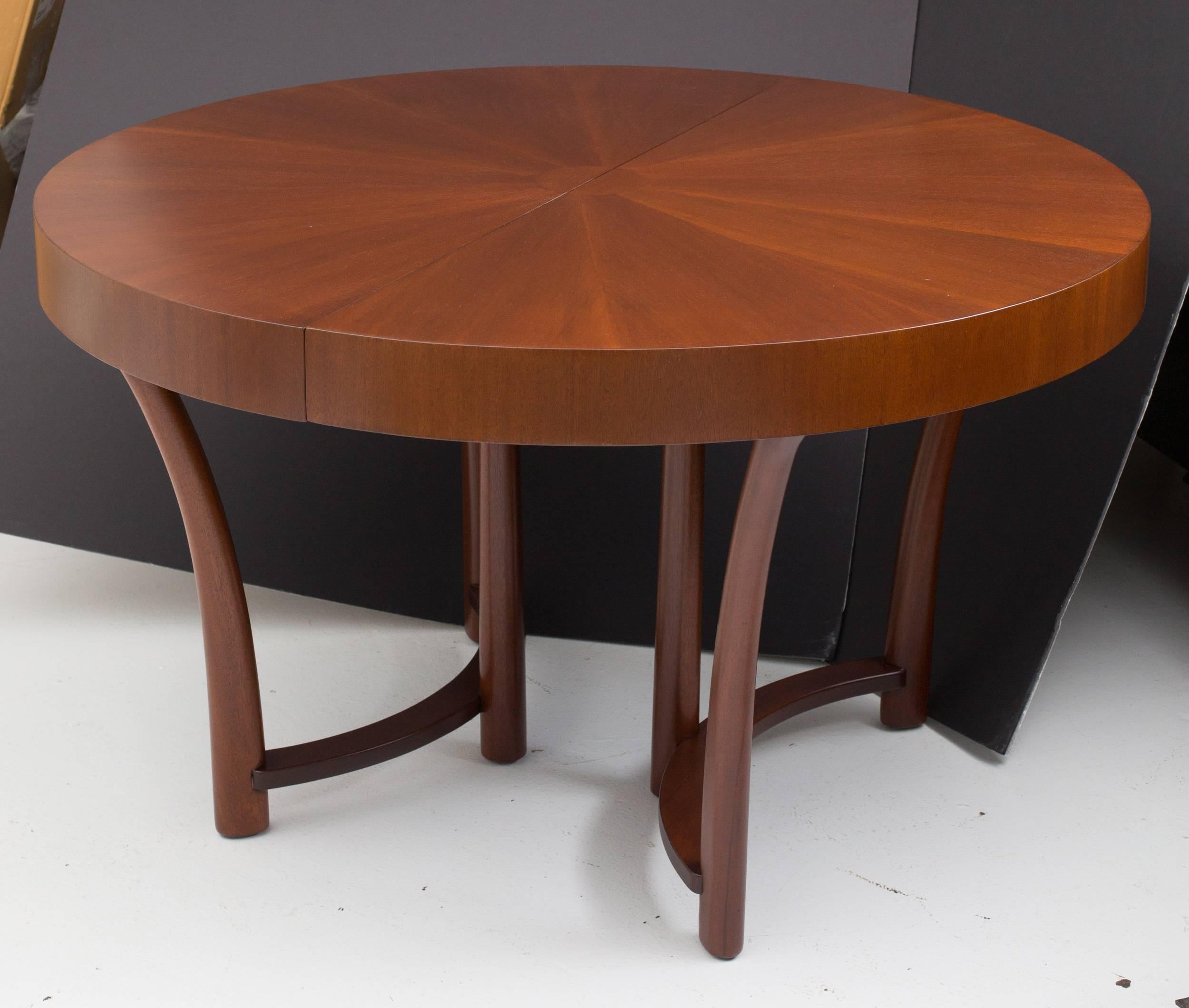 Round dining room table by T.H.Robsjohn-Gibbings 
for Widdicomb Furniture Co.,
with starburst veneer pattern top,
solid mahogany curved base and legs.
Three 12" W matching boards extend the top 
to 90" long oval shape.
