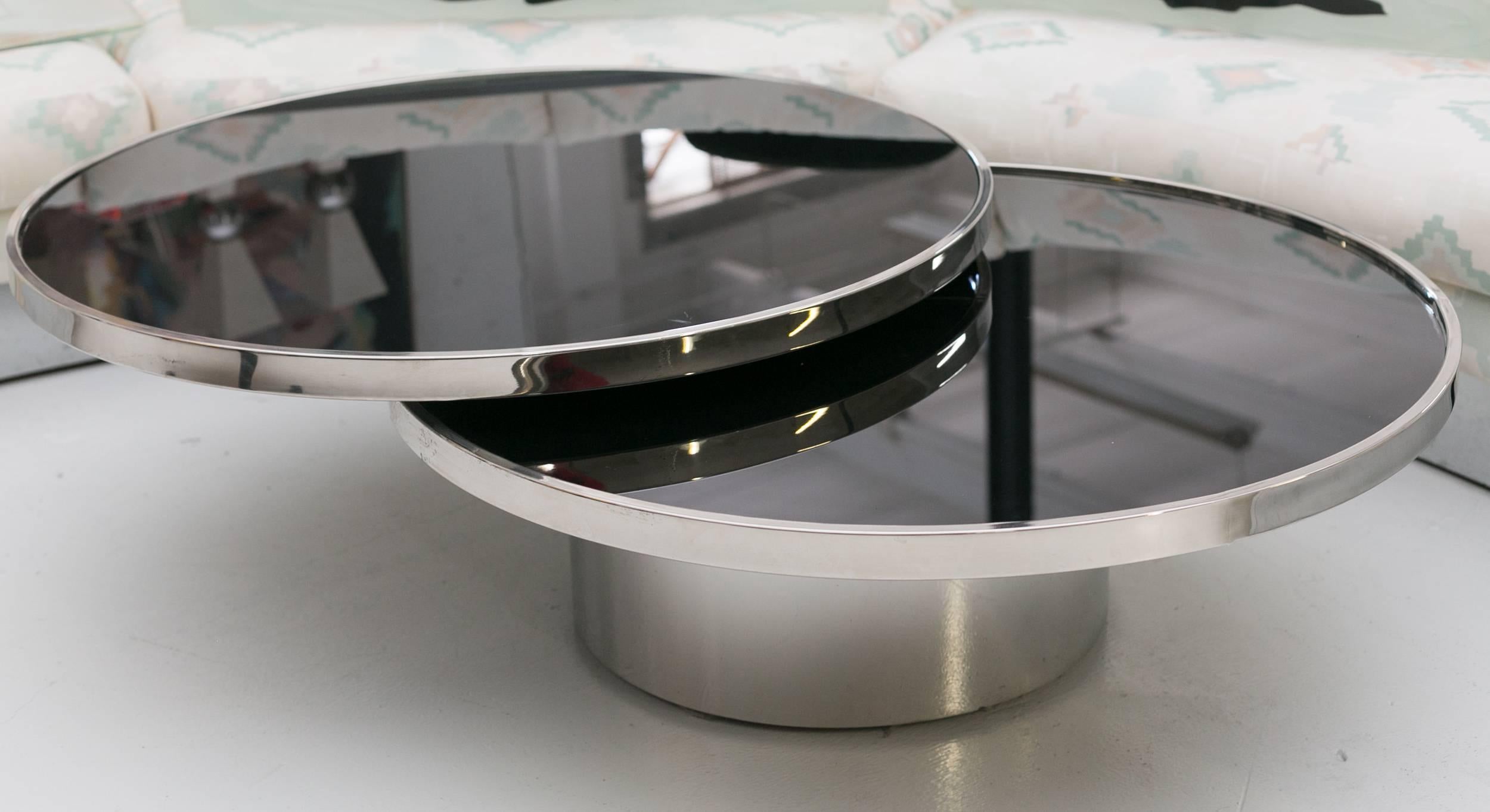 Revolving Cocktail table by Milo Baughman
with black back painted glass tops 
and mirror finished stainless 
steel rings and base.
Displayed @ Entrepot, Miami.
By appointment only.