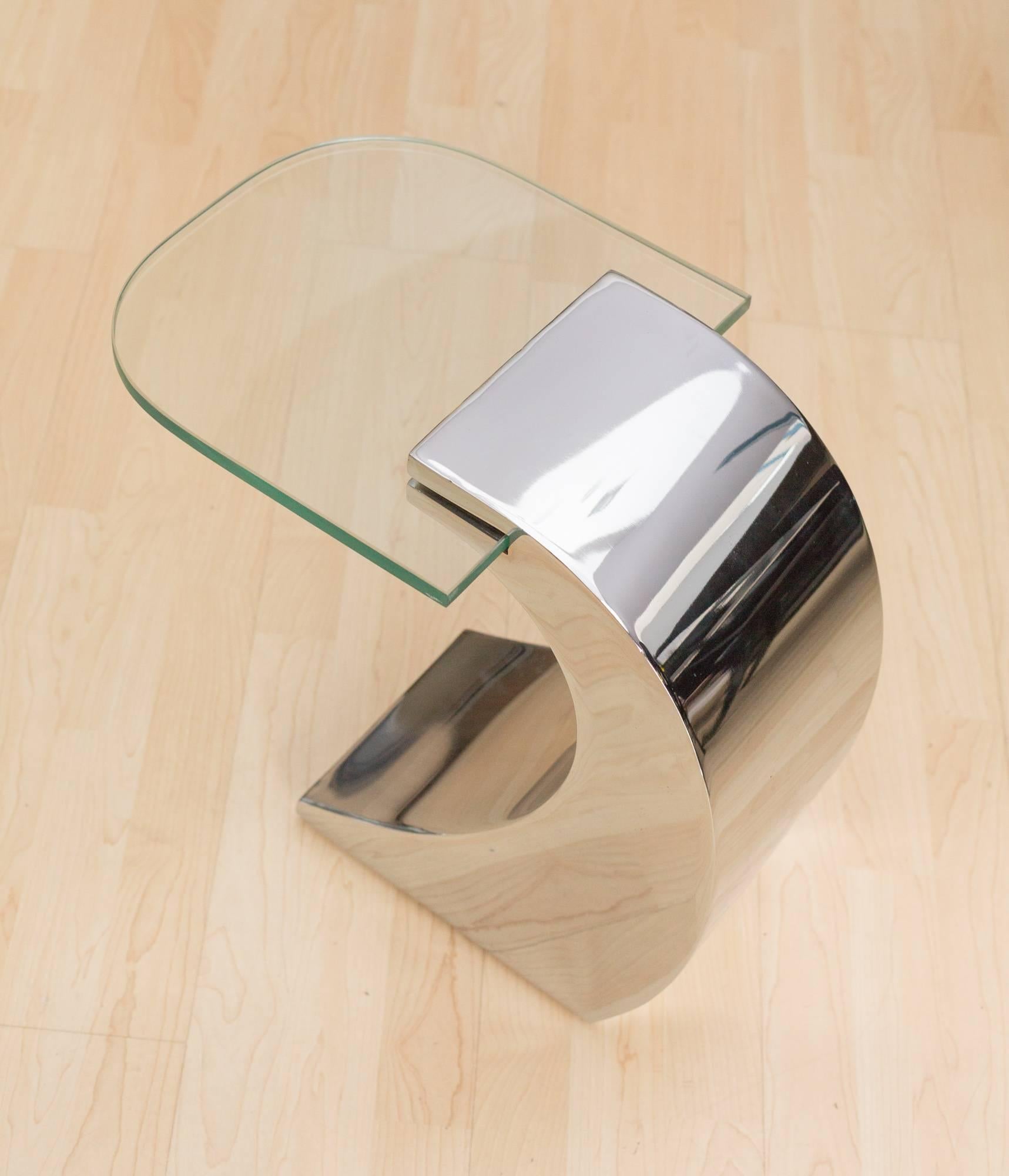 Set of 3 Wave Side tables by Pierre Cardin
With thick glass top (12"x12")
cantilevered from a wave shaped stainless steel base
(10" D x 8" W x 17" H) in mirrored finish.