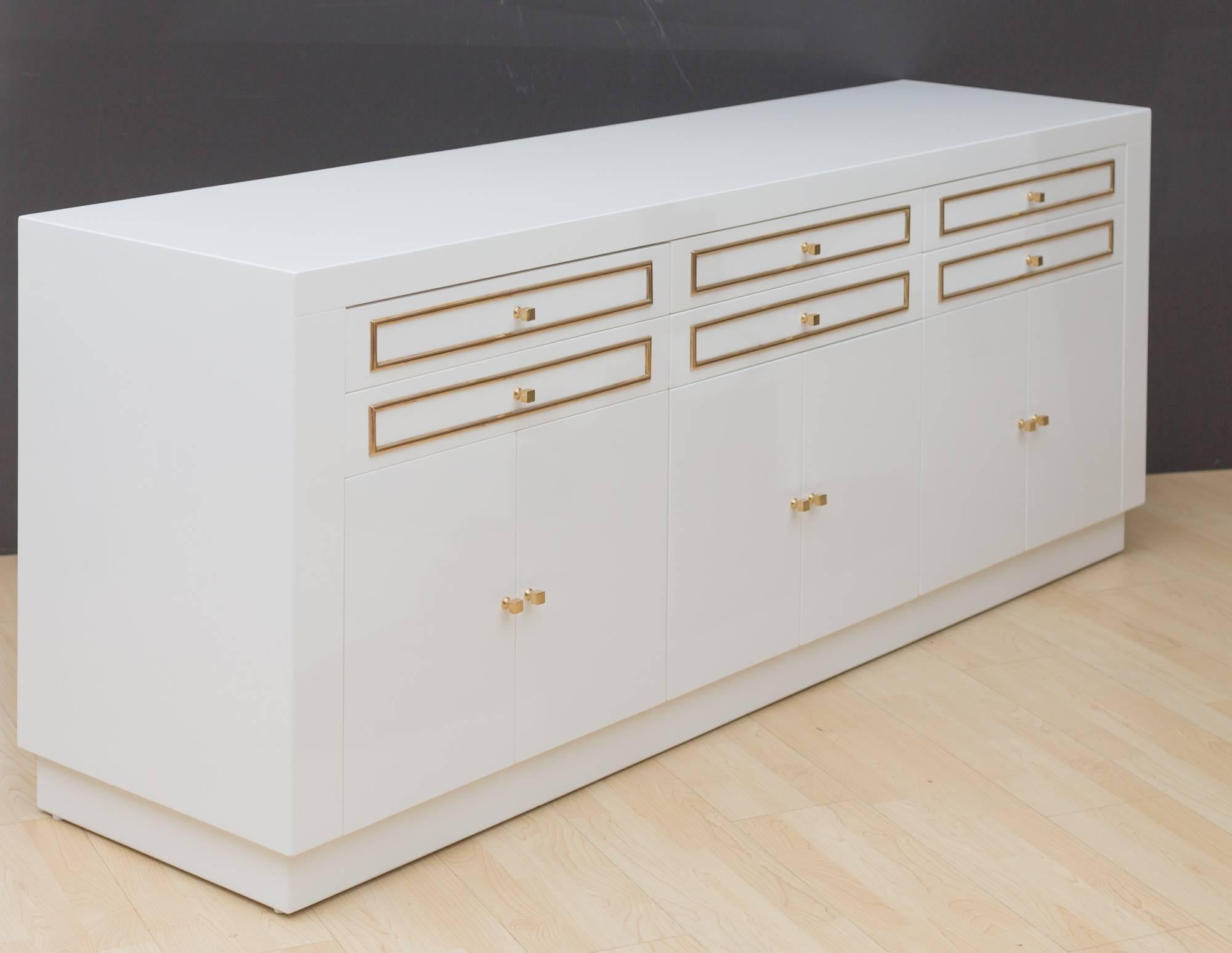 Elegant custom designed lacquered sideboard
featuring six measure: 3.75" H drawers with brass inlays,
three pairs of doors, all flash detailed for slick modern look,
with original solid brass cube pulls.
  