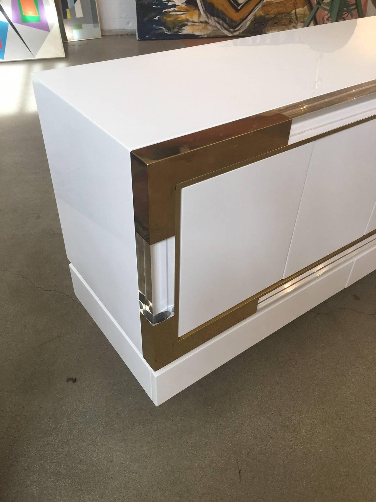 Metric Line Credenza by Charles Hollis Jones.
featuring four doors, solid Lucite edge details
and brass trim @ corners.
 