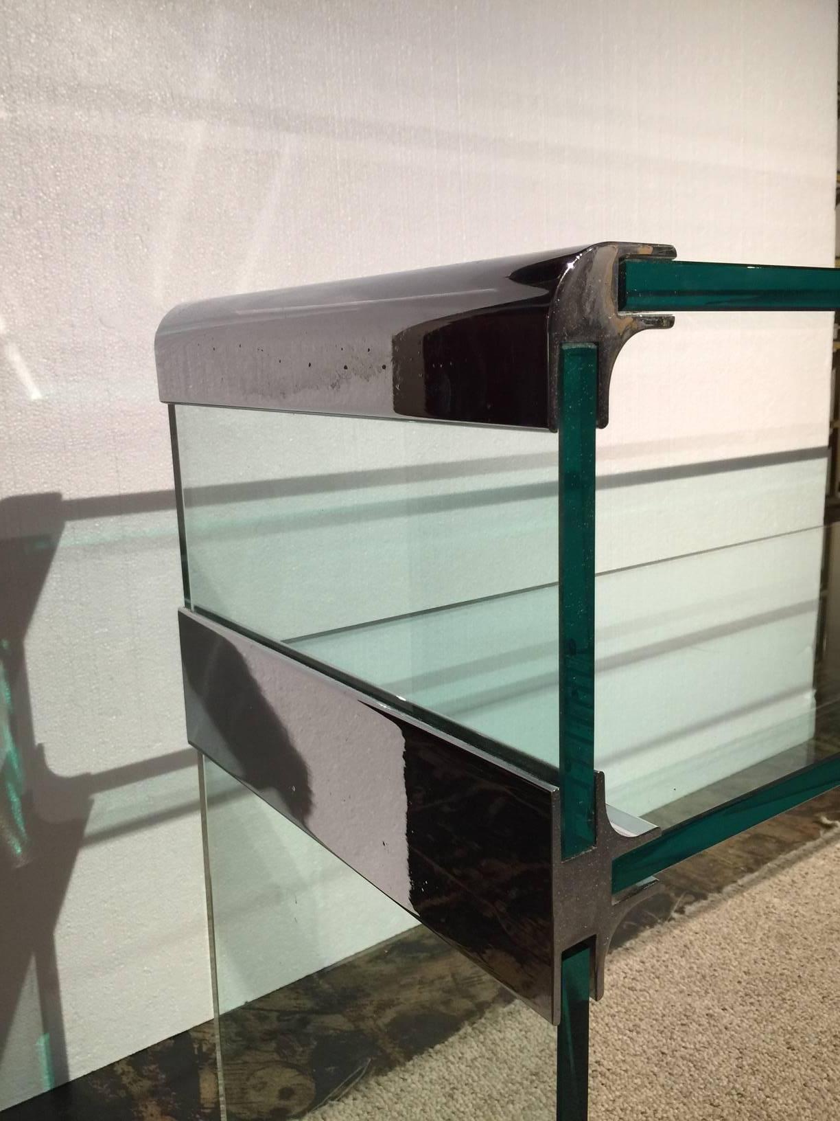 This very unique two-tier waterfall style console table with chrome accents.
 