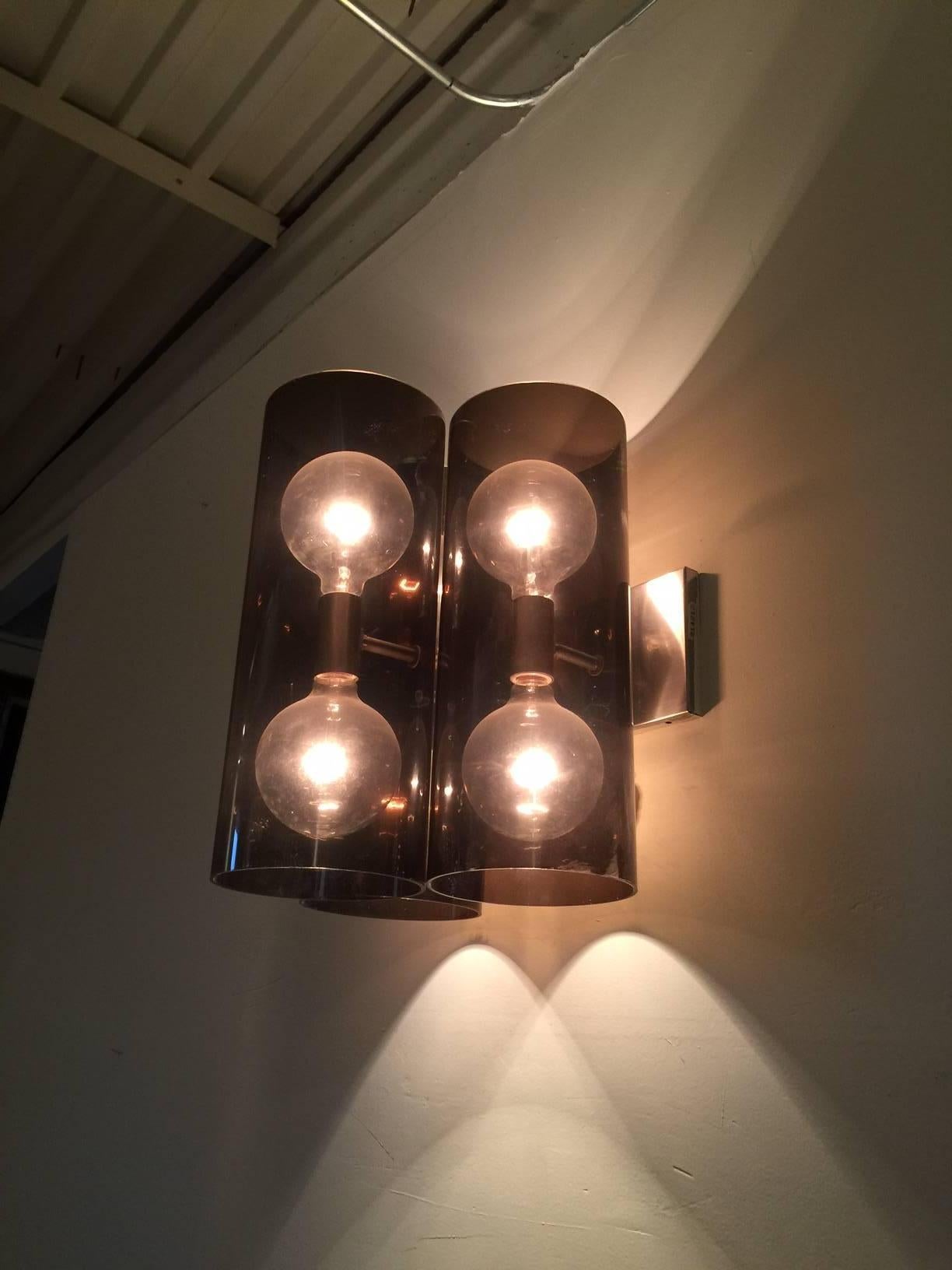 These wonderful vintage wall lights are comprised of three large cylinders in a smokey acrylic with six bulbs for a great source of light. There are three available priced and sold individually.

Note: This will ship from our MIAMI showroom.