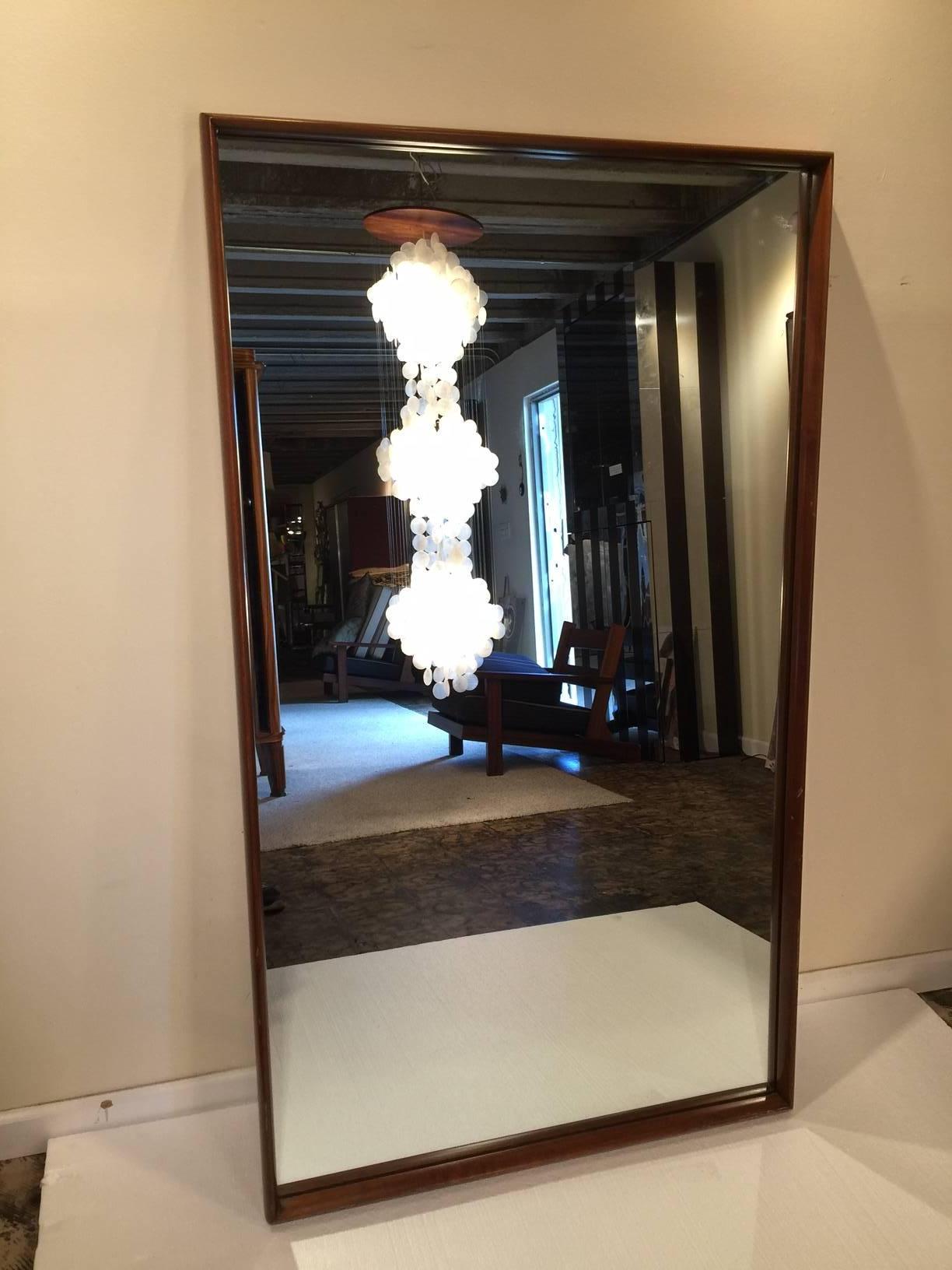 T.H. Robsjohn-Gibbings pier mirror of rectangular form with carved walnut beveled edge and original mirror plate.