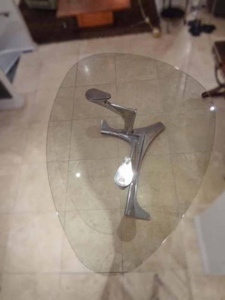 A rare and exceptional dining table featuring an abstract sculptural base in cast aluminum which bisects and supports a organically shaped thick glass top. The table is signed and numbered, 2 of 8, on the base by the artist. Gerard Mannoni, France,