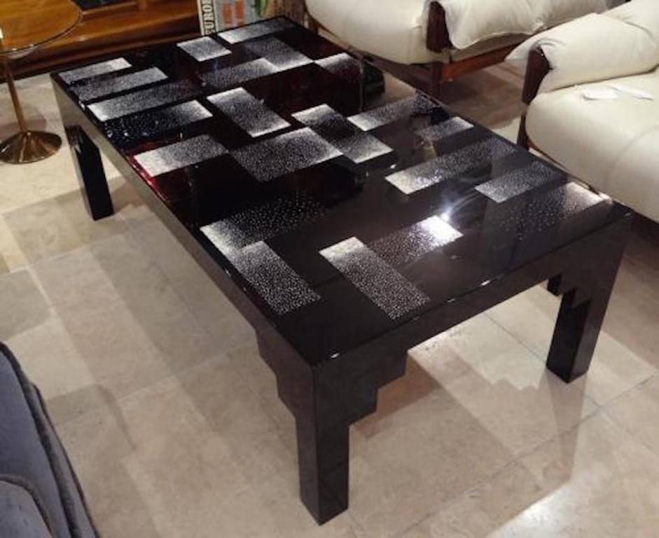 An exceptional cocktail table featuring a rectangular shaped body with square legs done in black lacquer which is decorated on the top with rectangular areas of eggshell lacquer. In the style of Jean Dunand, France, circa 1960.