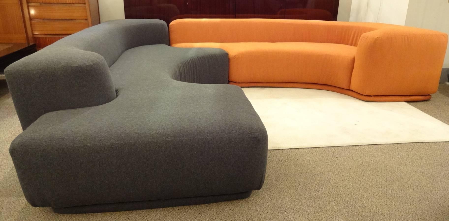 A modernist sectional two piece sofa, model "Lara", comprised of two shaped interlocking sections with a tight seat and back. The sectional was designed in 1958 but produced in 1968. It has been newly upholstered in a charcoal and pumpkin