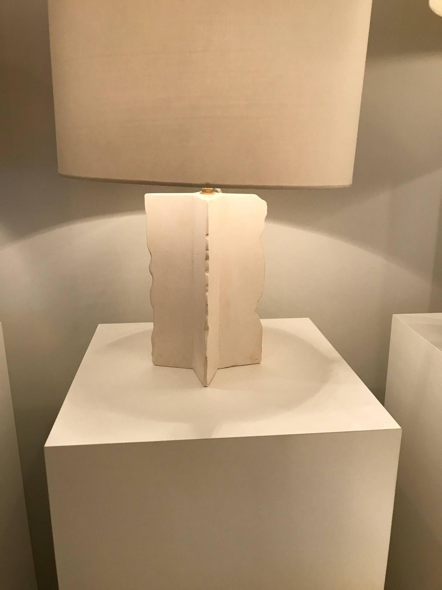 The Antic Comet table lamp is handcrafted in the Paris atelier of Julien Barrault. Base in sculpted white plaster with a handmade white shade. Made-to-order.