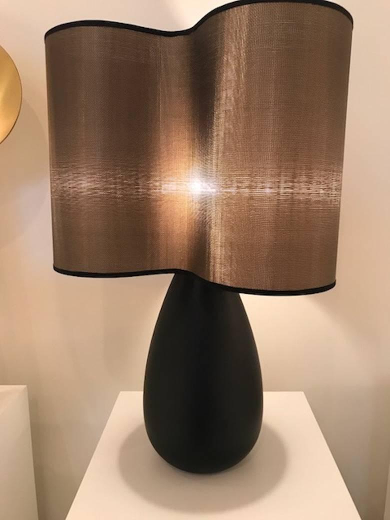 The clover table lamp is handcrafted in the Paris atelier of Julien Barrault. Available in large or small size in stained wood with a bronze clover shaped mesh lampshade.
Small size has a diameter of 12