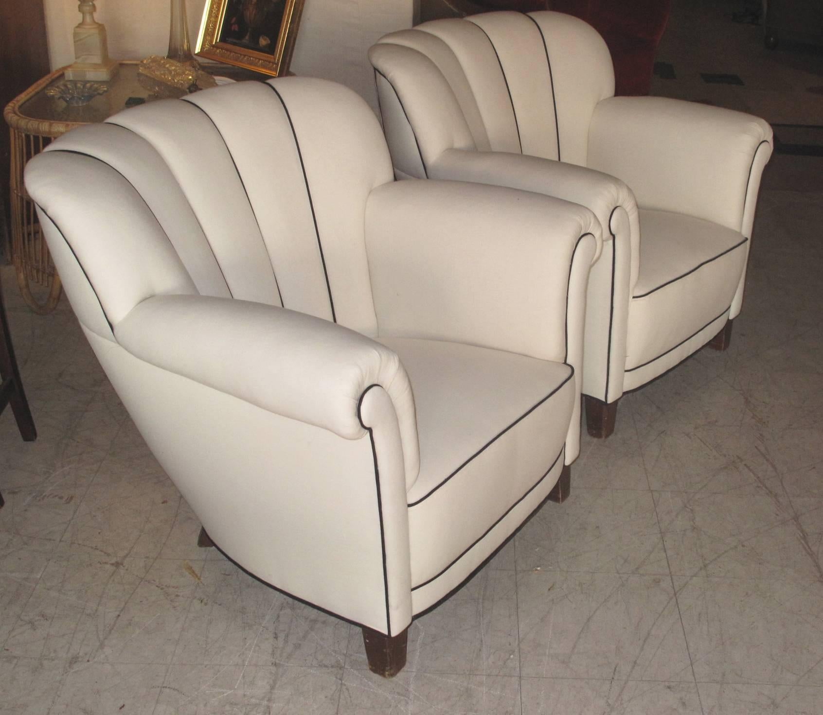 Really comfortable pair of large-scale Danish, 1940s channeled-back club or lounge chairs newly upholstered in white linen with black piping.