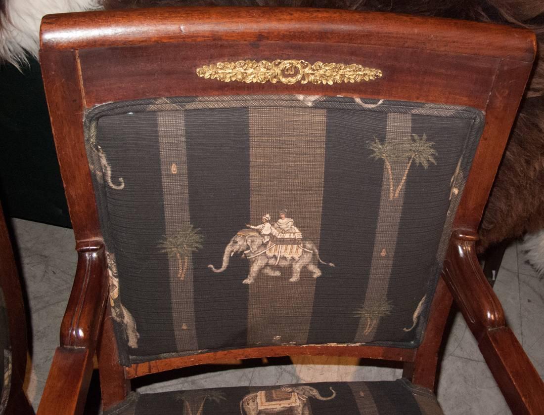 Empire style late 19th-early 20th century furniture suite consisting of a pair of chairs and a settee. The chairs and settee of mahogany with gilt-metal mounts.
The chairs and settee upholstered in a good quality striped fabric with an Indian