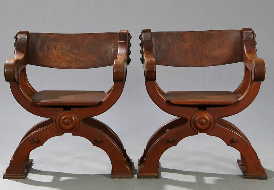 A nice pair of oak frame Savonarola style chairs with leather backrests. Danish; late 19th-early 20th century. (See similar pair in Game of Thrones (Tyrion's council chamber in Meereen).