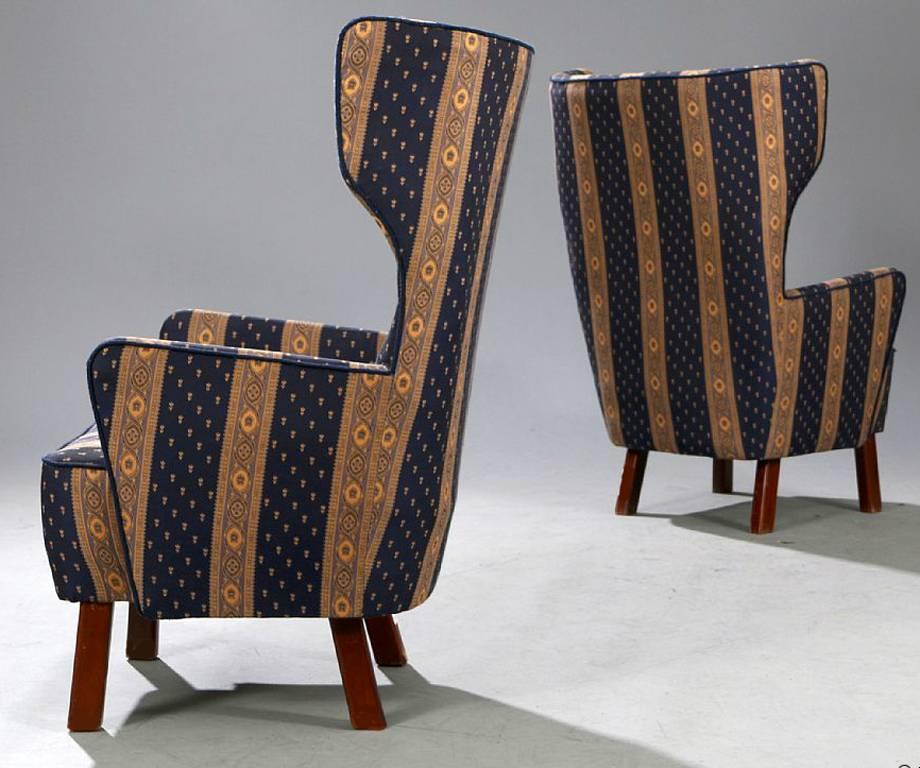 Pair of Danish 1940s stained beechwood frame wing chairs upholstered in a patterned fabric.
