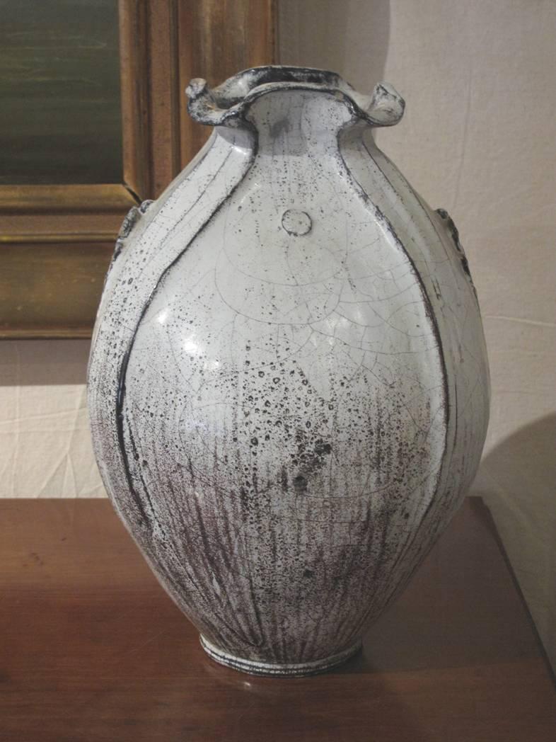 Large-scale vase in tones of white and black. The vase with shaped mouth and foliate decoration on either side. The vase by artist Svend Hammershøi for Kähler Pottery, circa 1940s.