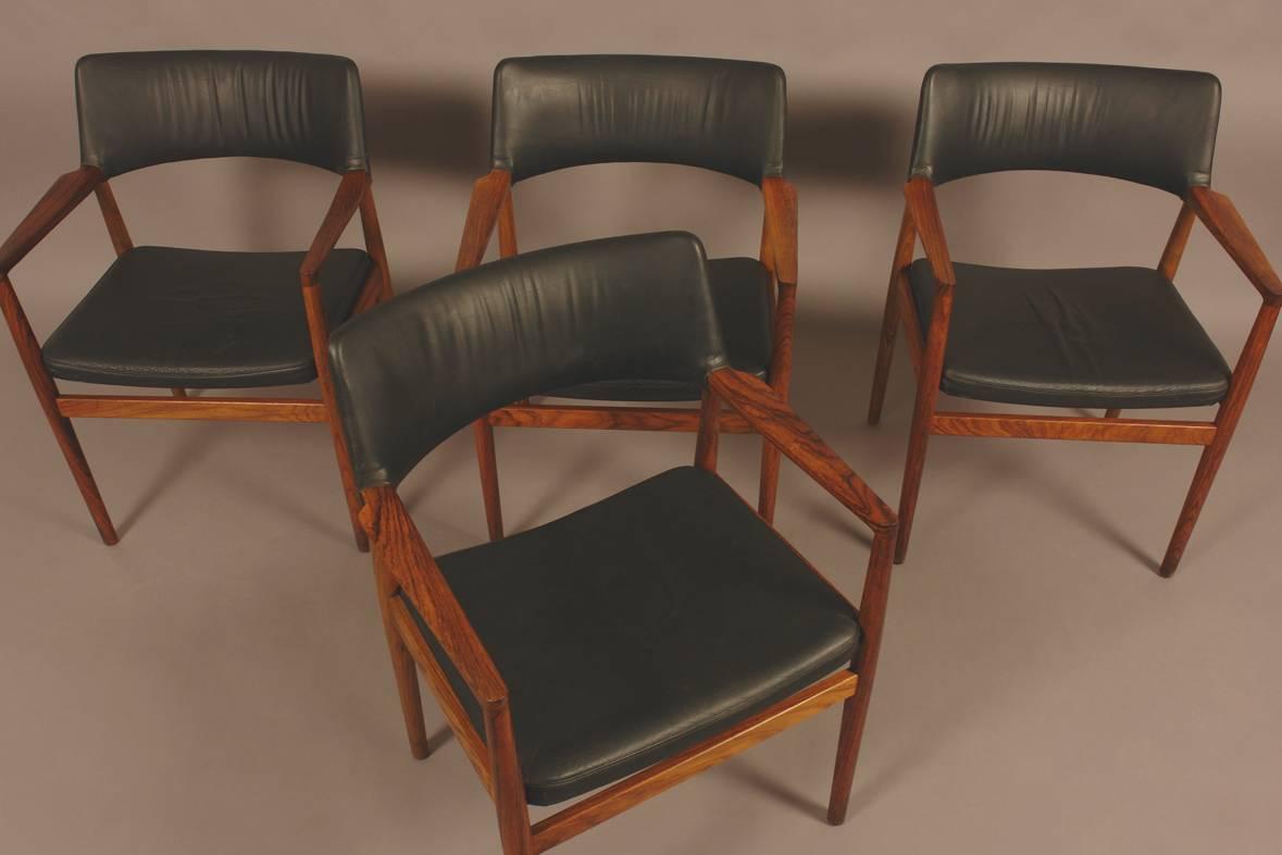 Four Danish modern black leather upholstered armchairs of highly figured rosewood. The chairs by Danish designer Erik Wørts. The chairs manufactured in 1966. Note: Would sell as pairs.