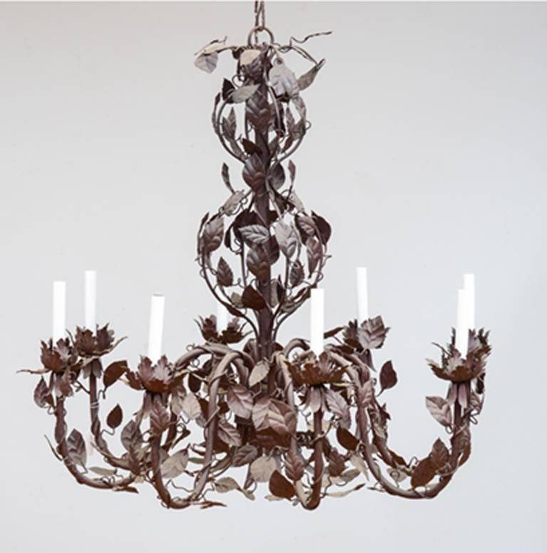 Large French tole chandelier mounted with vinework. The chandelier of a dark burgundy color. The chandelier, circa 1920s-1930s.