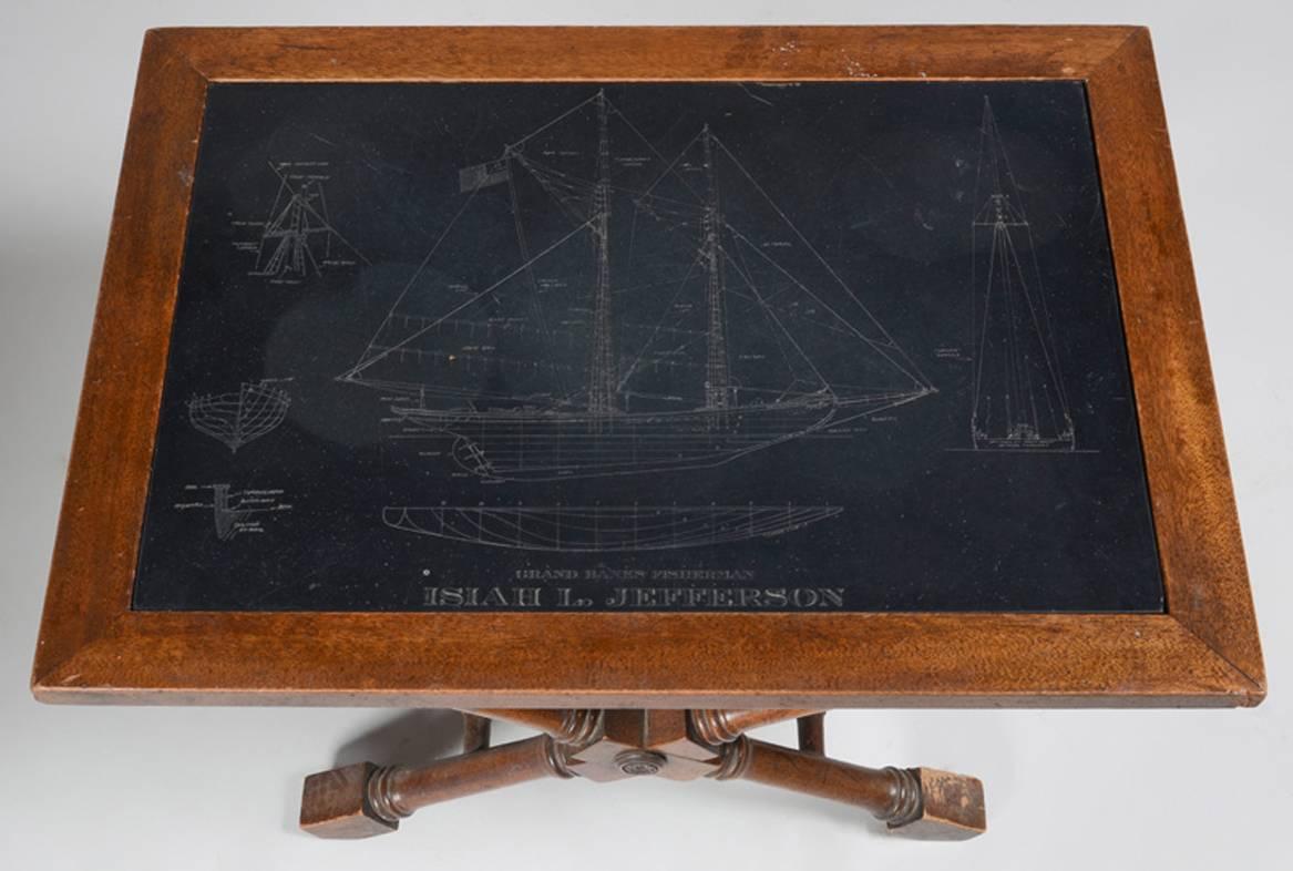 Low side table with an inset slate top engraved with blue prints of a clipper ship 'The Isiah L. Jefferson'. The top inset into a Regency style carved oak table base.