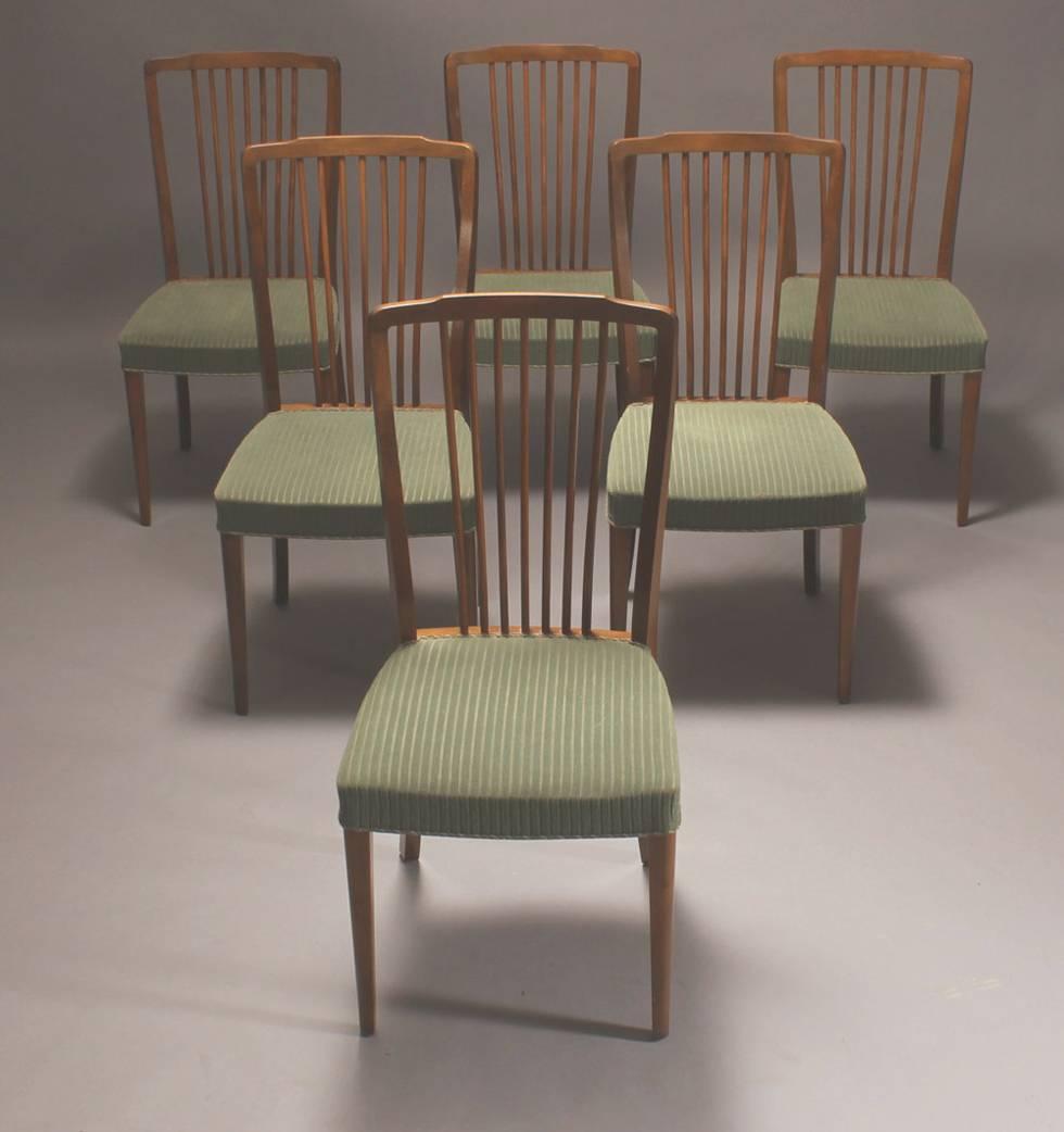 Set of six Danish early 1950s-1960s spindle back dining chairs of stained beech wood.