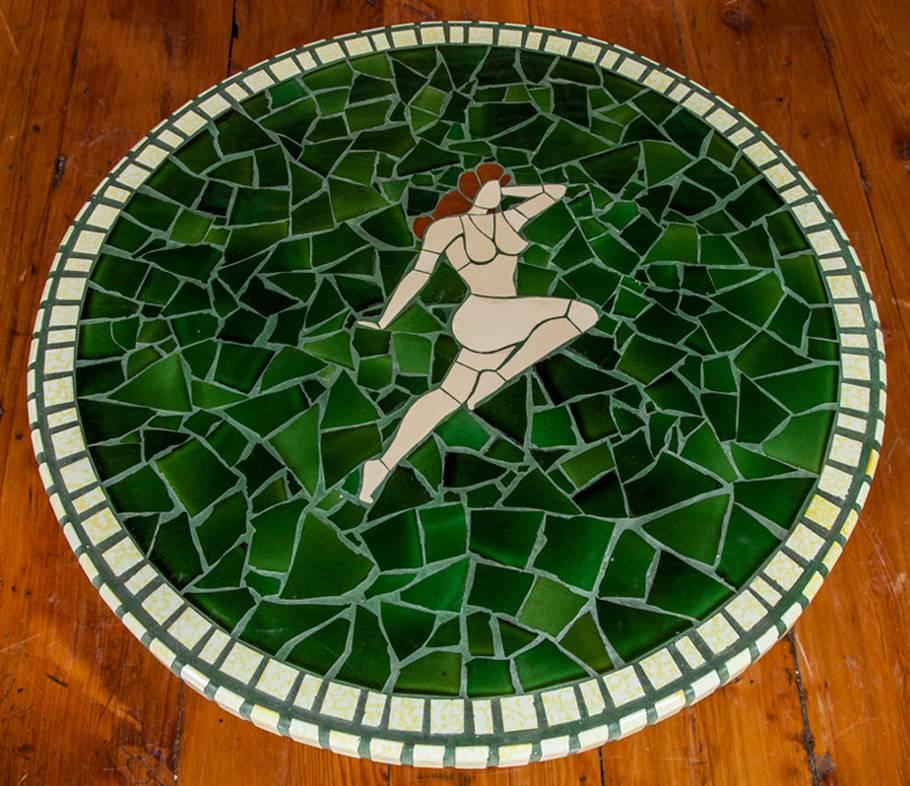 A good quality Danish 1960s,  probably designed by Danish architect Philip Arctander,  Coffee table comprised of a mosaic tile top inlaid with a nude stylized female figure. The top supported by three oblong shaped oak legs.