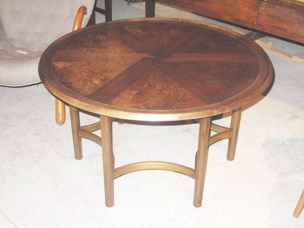 The dished top of beautifully figured rosewood and crossbanded decoration. The table raised on straight legs joined by incurved stretchers, circa early 1960s.