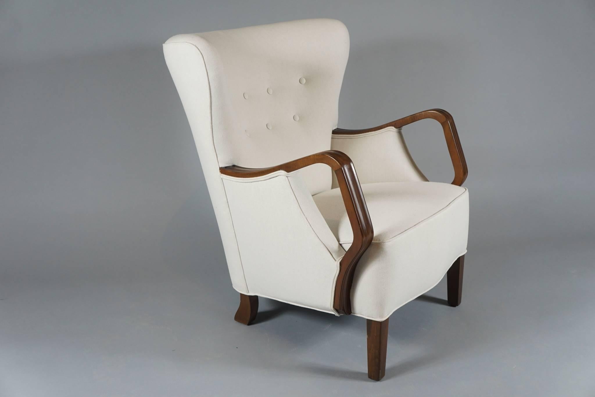 Pair of architectural armchairs by Danish cabinet-maker of sound structure with walnut frame and open-arm.