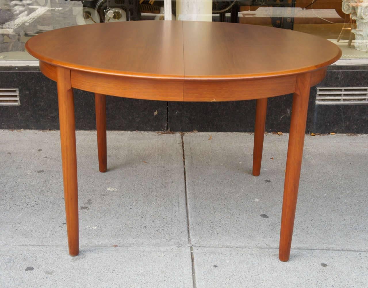 Classic Danish Modern dining table in teak
The table with a nicely figured top with cross-banded edge on four tapered legs. The table with two 19 7/8