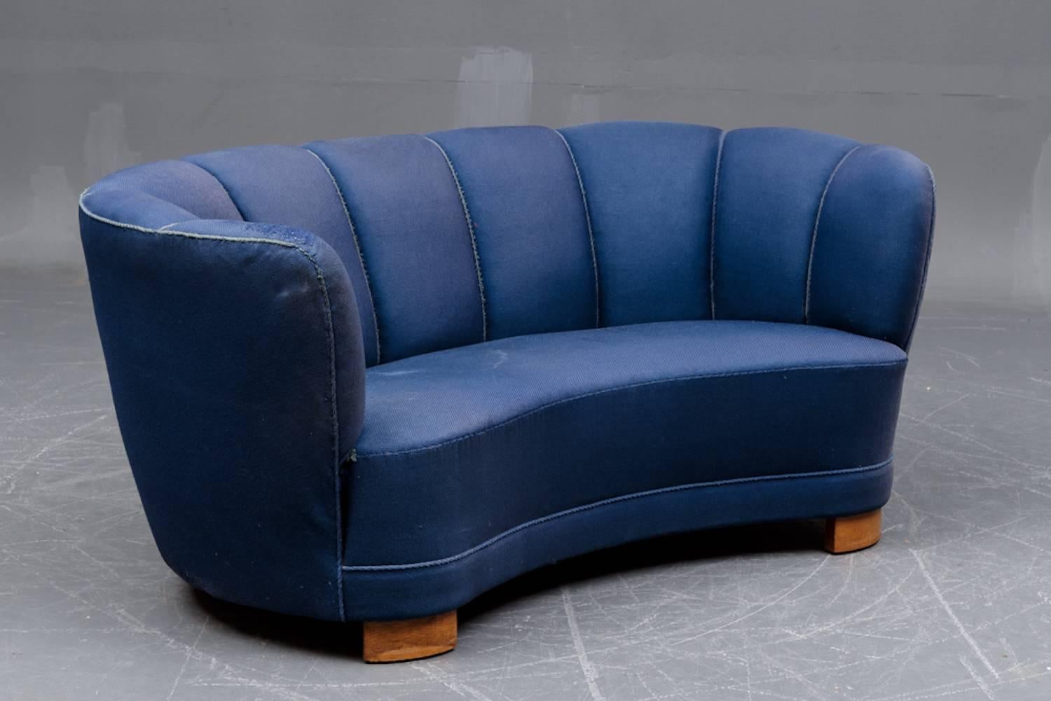 Blue covered banana form sofa from Denmark, Mid-Century Modern on beech 
legs. Needs recovering fabric worn and has a small hole plus a darned hole. 
Popular form, from Slegelsee Fabrik, we have several others in different colors, 
green, gold,