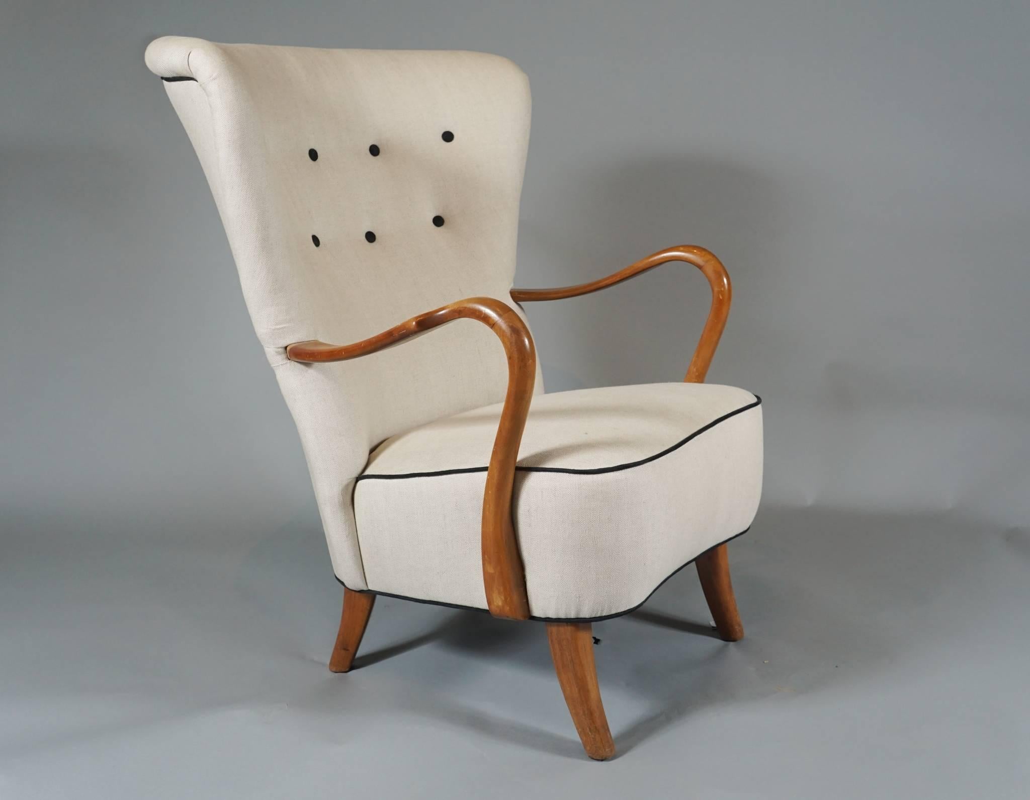 Large-scale 1940s open armchair by Danish cabinetmaker Alfred Christensen, upholstered in linen with black piping and buttons. The frame of beechwood. Note: We have similar chairs available if a pair is required.