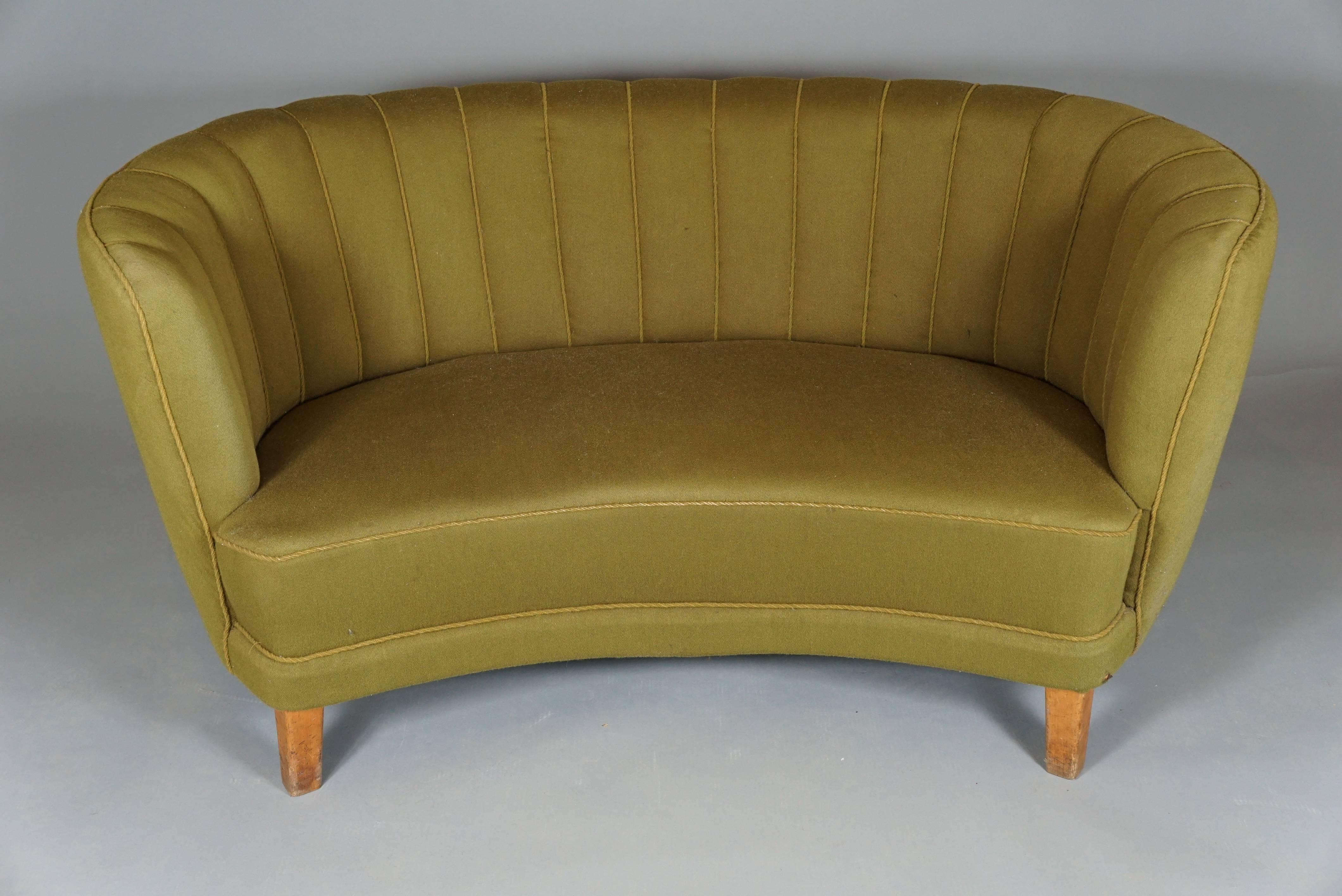 Danish Art Deco banana form sofa with channeled back upholstery and beech legs.