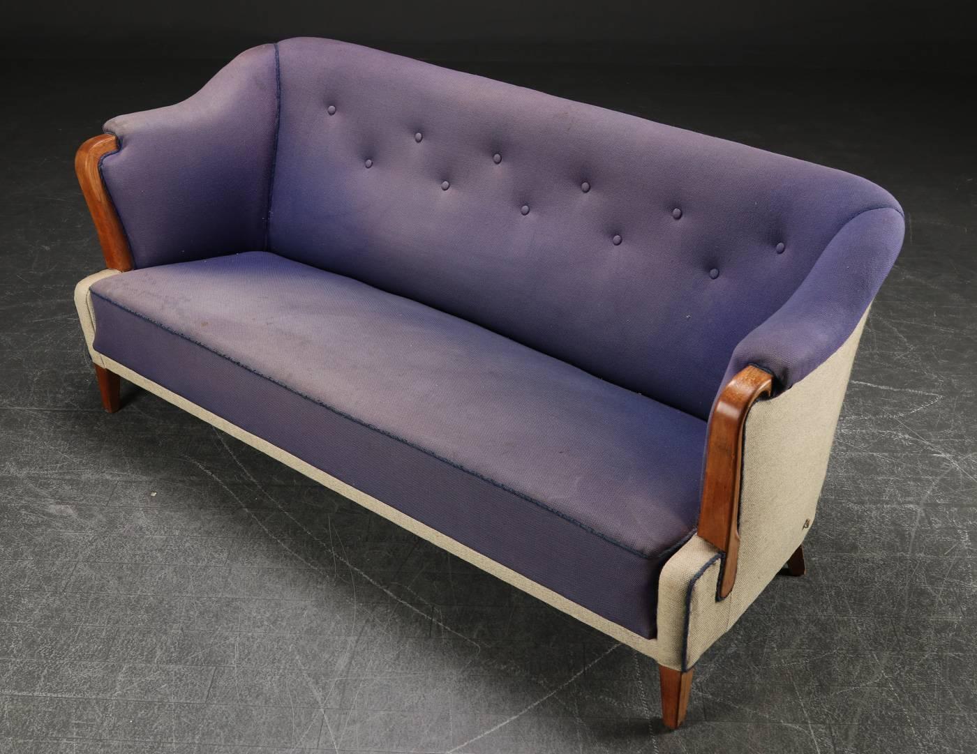 Danish sofa of architectural form, circa 1940s.  Arms and front legs in oak, 
back legs in beech.  Two tone upholstery, purple is faded.  