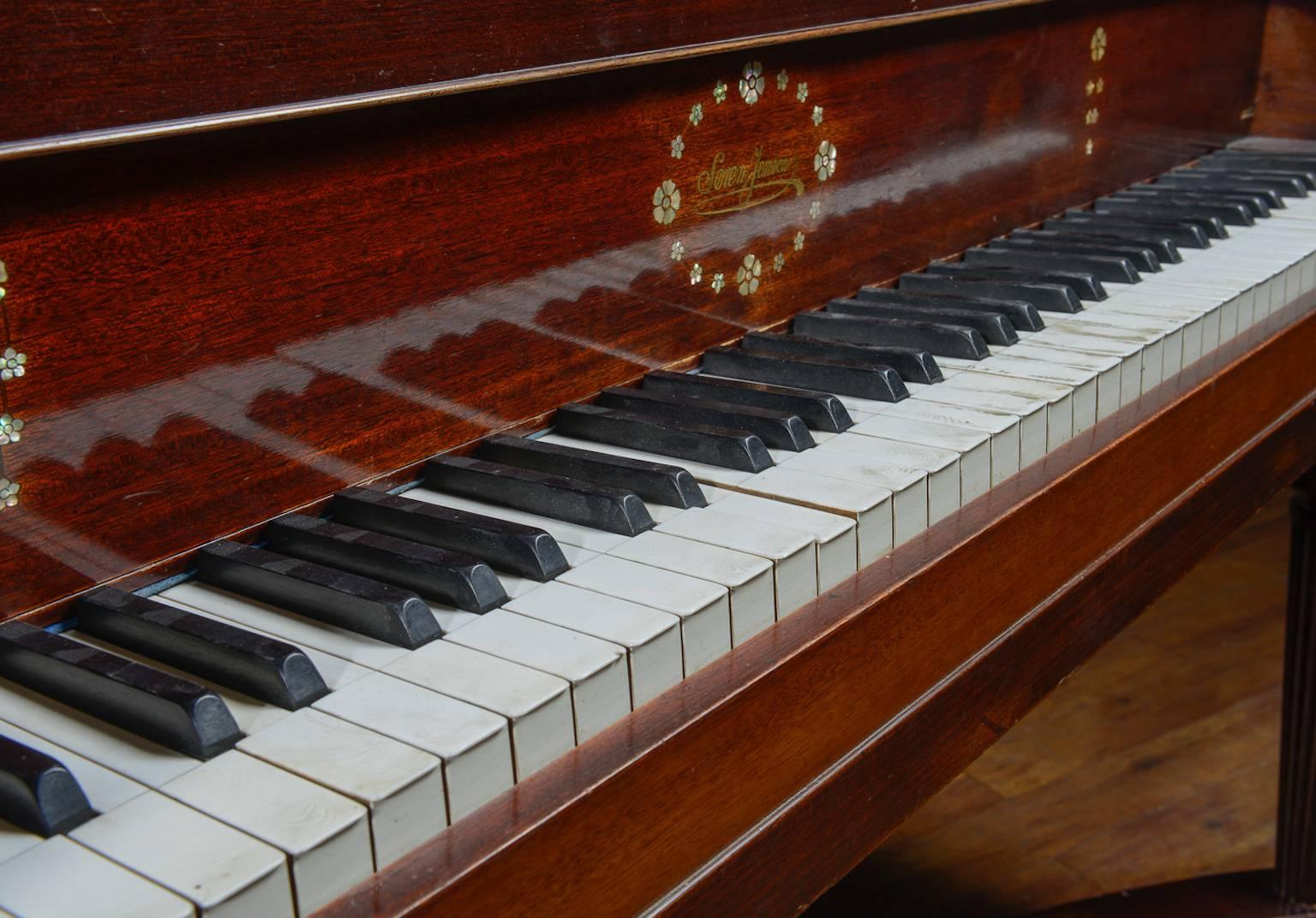 Beautiful baby grand piano made by a well-known Danish company, Soren Jensen, in the 1920's, with an unusual case design in that the lids take the form of butterfly wings when raised. The case is mahogany with mother-of-pearl inlay. Please note that