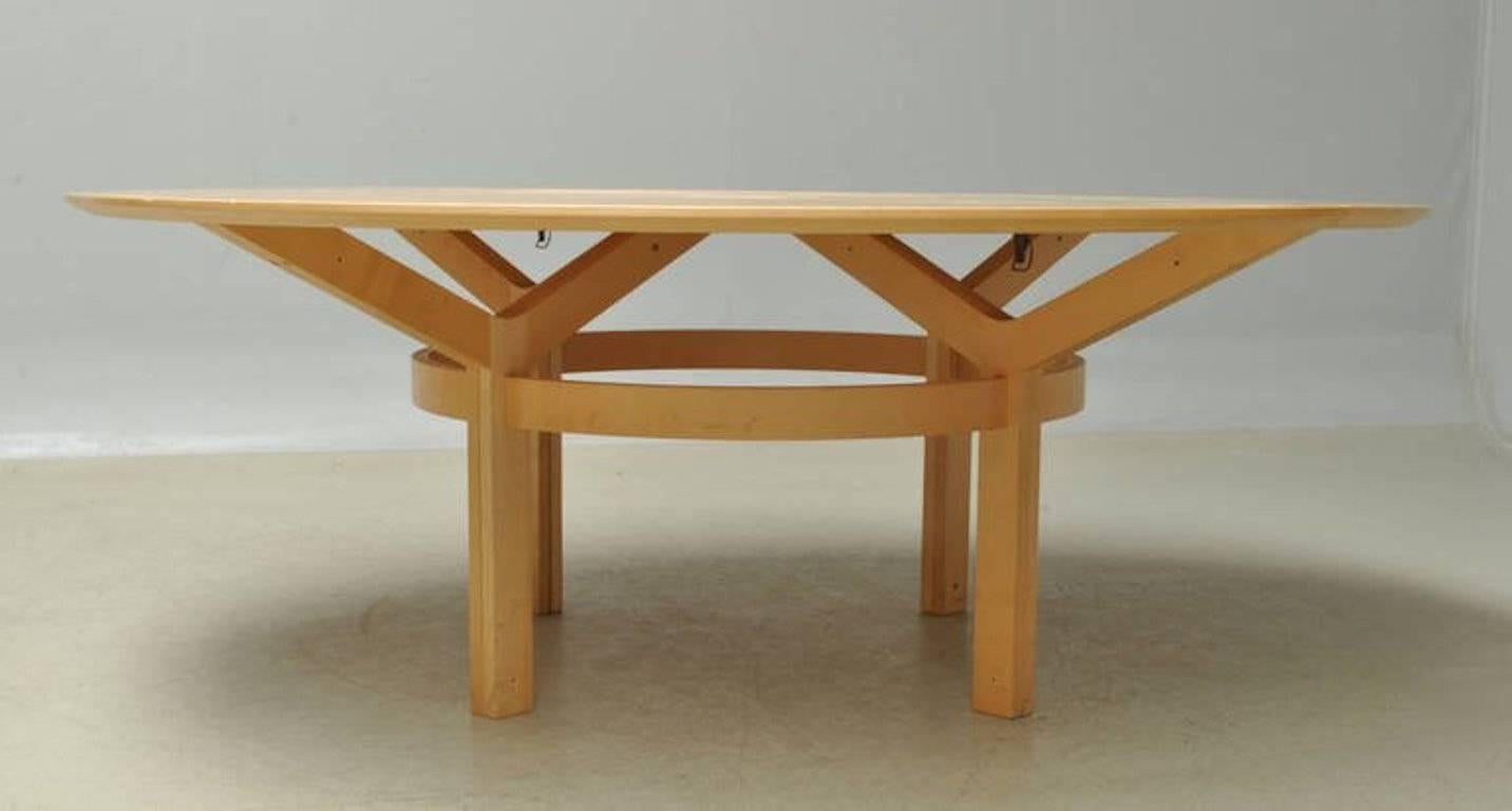 Danish modern large circular dining table by Rud Thygessen and Johnny Sorensen in pale maplewood. 
Seats ten easily. Eight chairs also available also in maple and ebonized, with black leather seats.