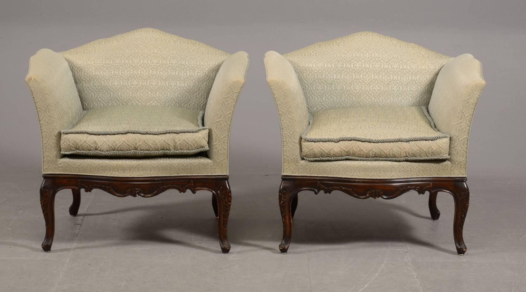 Pair of French Bergere mahogany armchairs, upholstered in the original damask. The cabriole legs carved with floriate detail. 