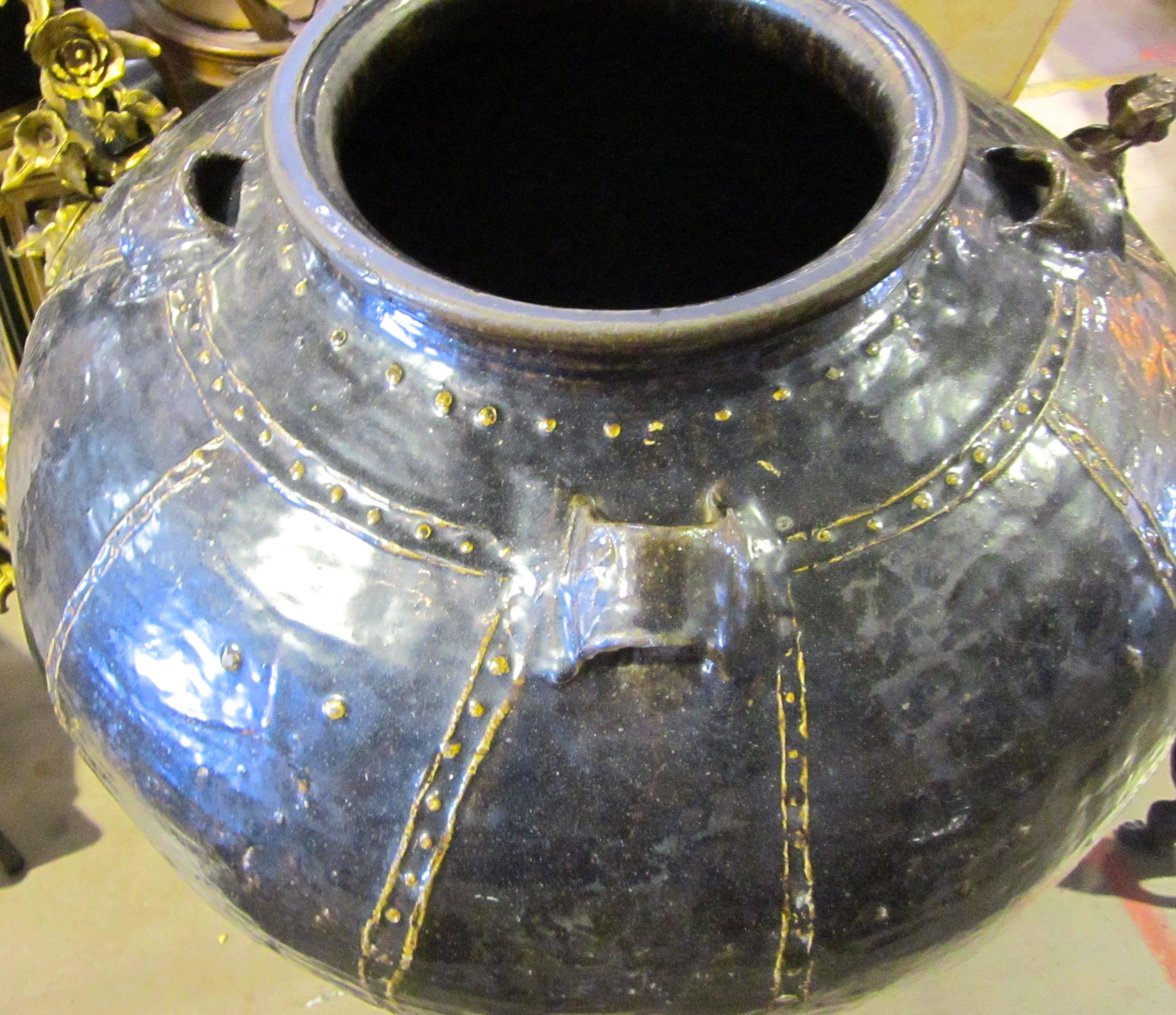 19th century Chinese extra large black terra cotta jug with four handles.
A brass color chain motif design adorns the jug.
