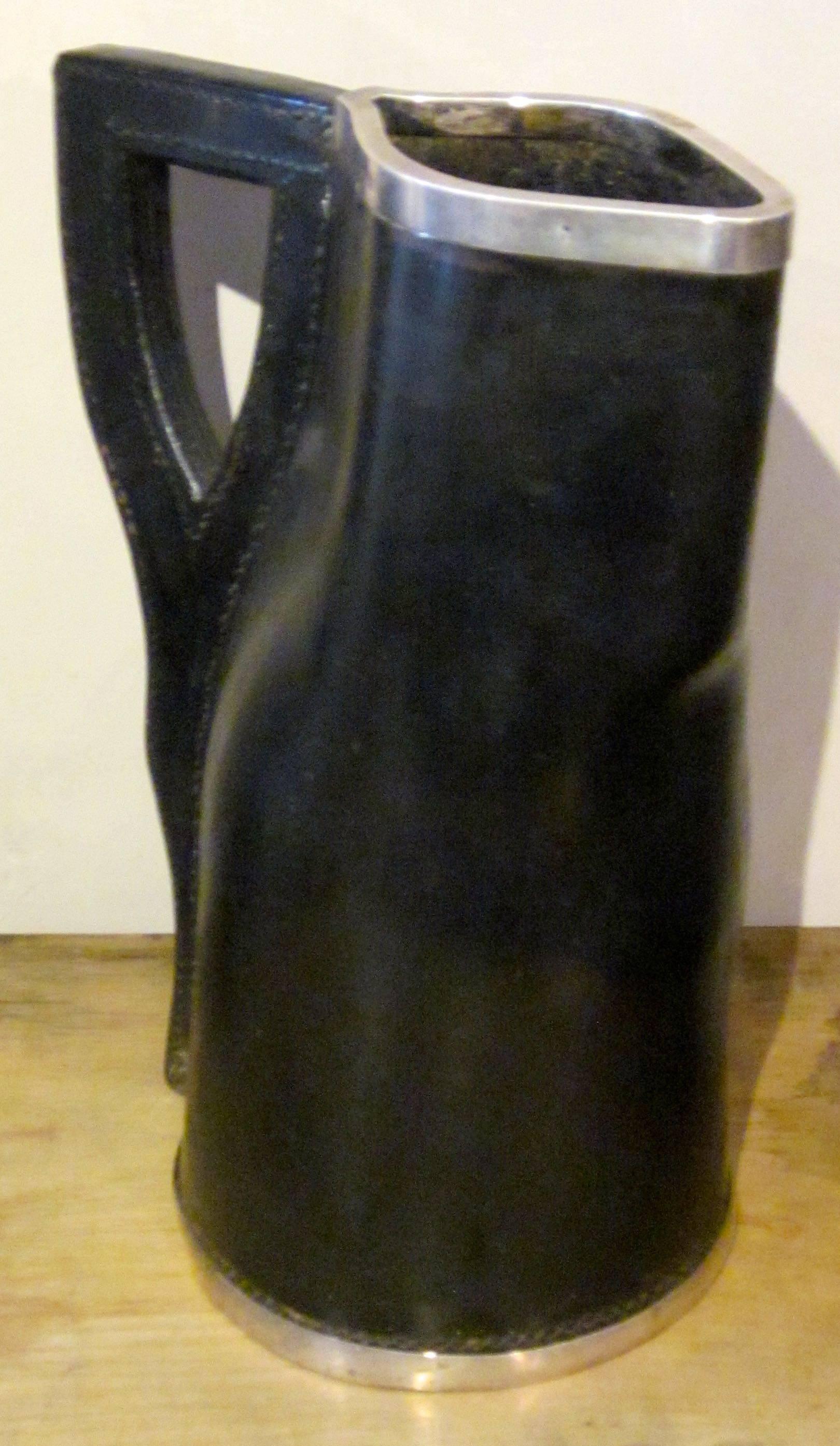 19th century English black leather pitcher has sterling silver trim at top and base.