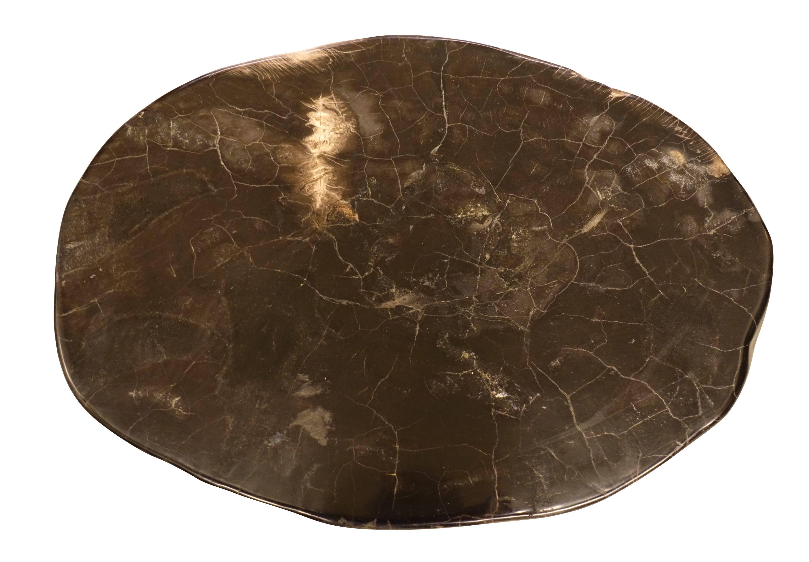 Contemporary Indonesian highly polished oval shaped smooth petrified wood cocktail table.
Black with areas of cream.
