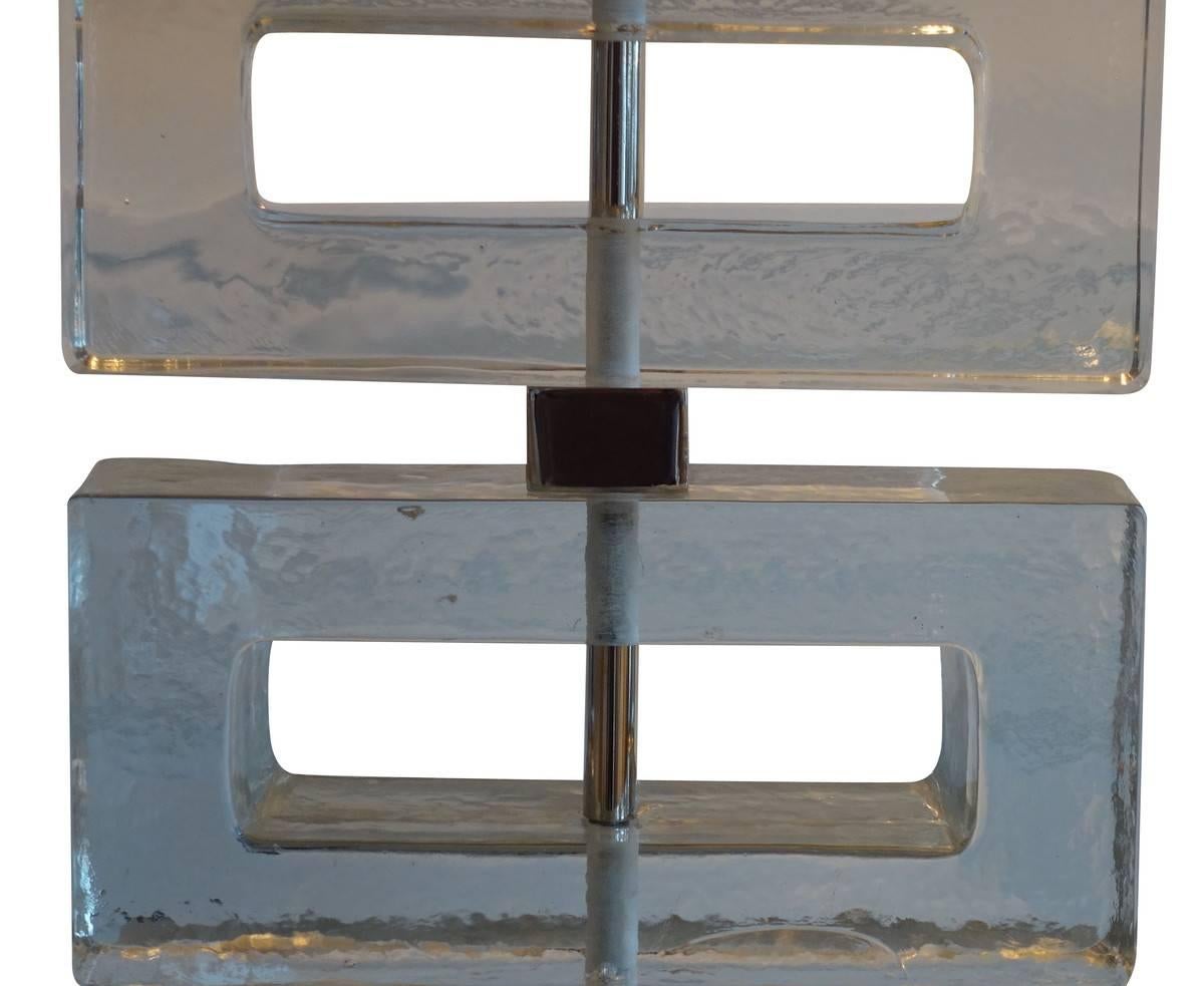 Two rectangular donut shaped textured glass forms are the base for pair of lamps from Belgium.
Shade measures 17