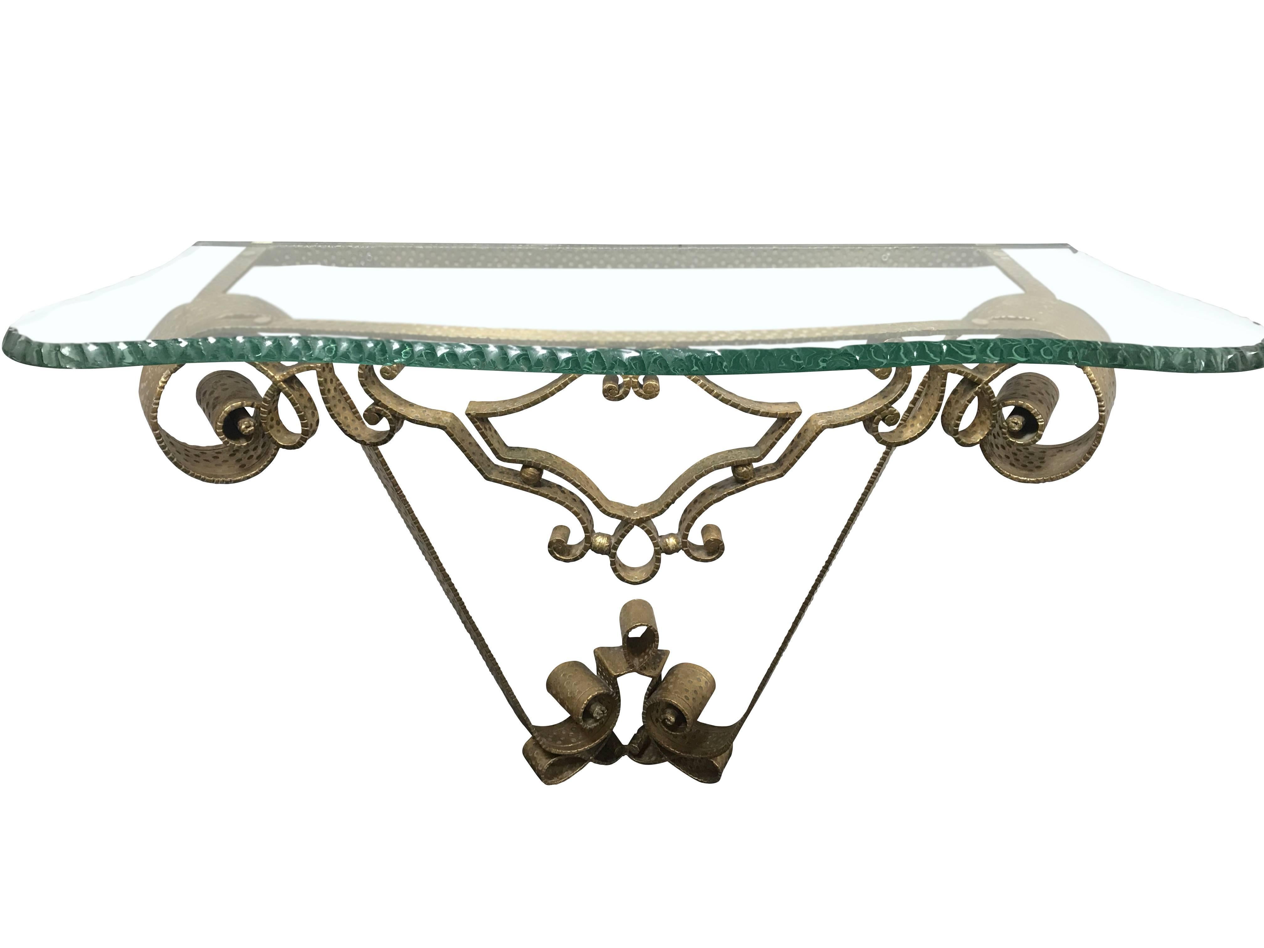 1950s Italian pair of hammered bronze console tables designed by Luigi Colli.
Top of thick chiselled glass in curved shape.
Decorative whimsical base.
Trademark Luigi Colli design pattern.
