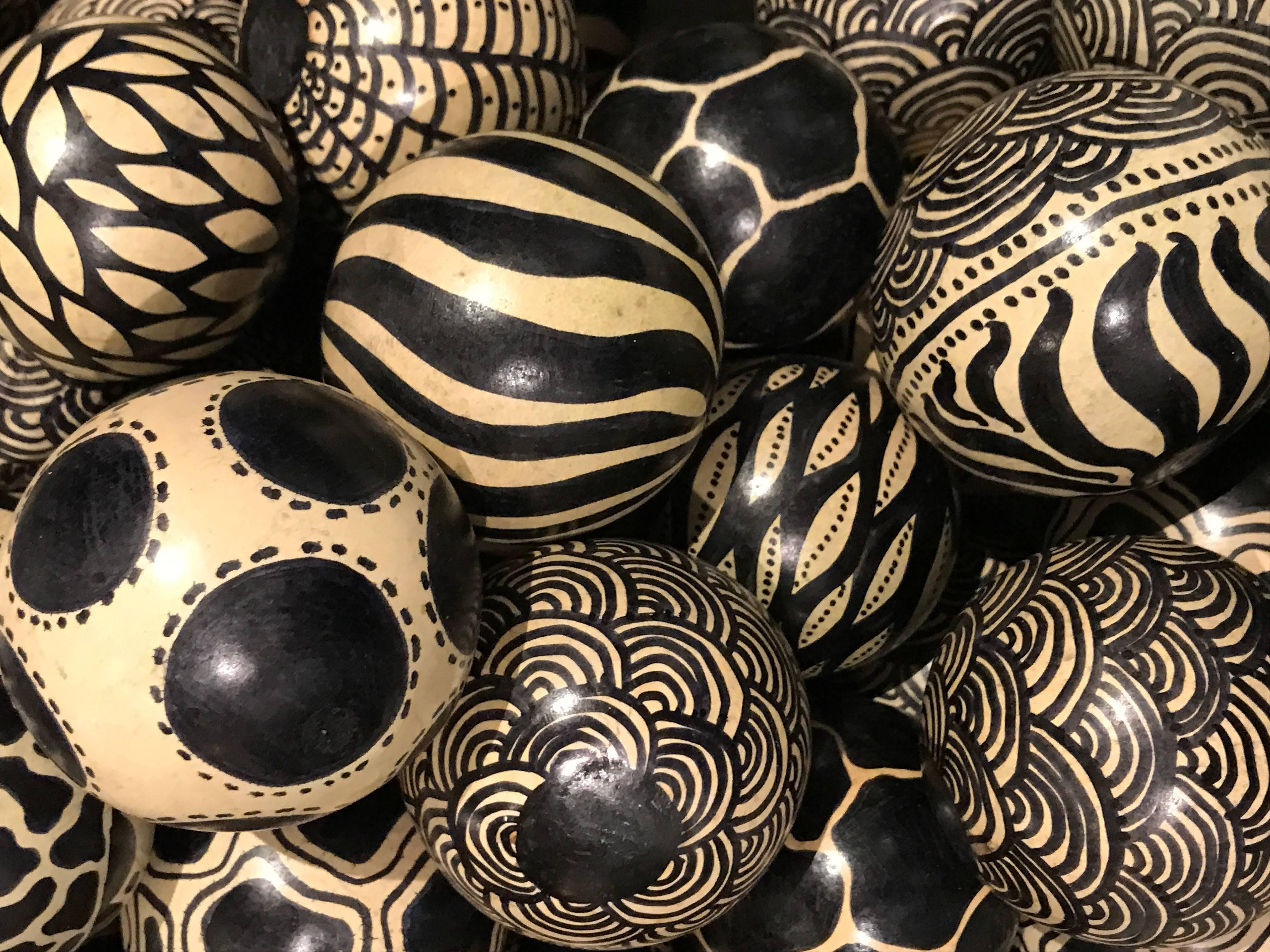 Contemporary Zambian hand-painted monkey oranges by villagers in Zambia.
Black and cream in coloration.
Several different designs.
Sizes are 2.5